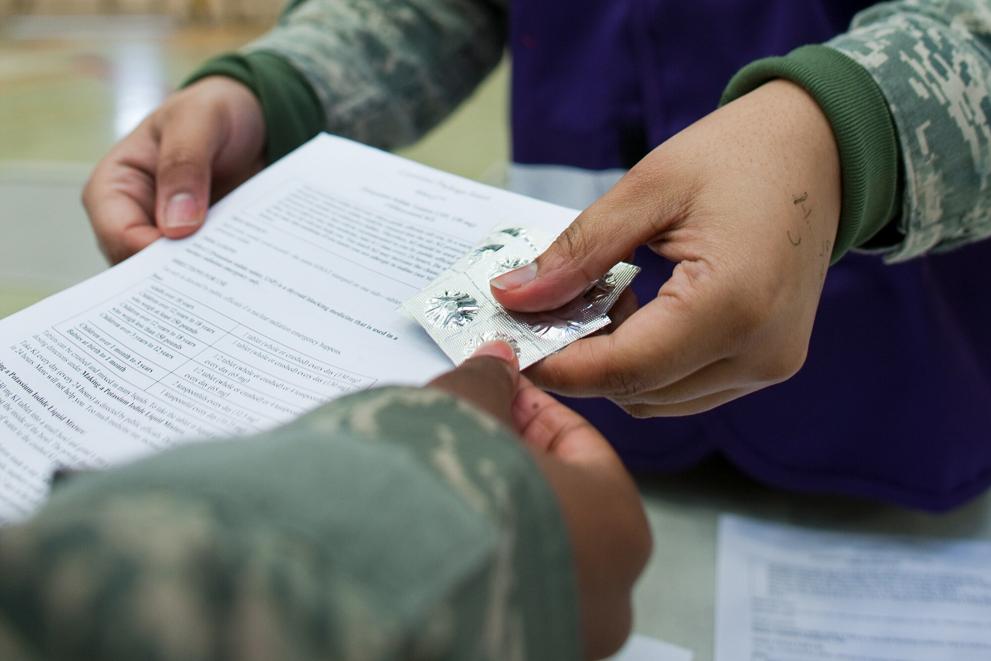YOKOTA AIR BASE, Japan -- The 374th Medical Group starts distributing Potassium Iodide (KI) tablets at Hanger 15, March 22. U.S. Pacific Command directed distribution of potassium iodide tablets as a precautionary measure.  Base officials are stressing there is no indication of increased exposure at Yokota AB.  Anyone wishing to receive KI tablets is required to fill out a form, available on the base Website at www.yokota.af.mil under "Japan Relief." One representative over the age of 18 can pick up packets for their entire household between 10 a.m. to 10 p.m. today at Hangar 15. For more information, call 225-7342. (U.S. Air Force photo/Osakabe Yasuo)
