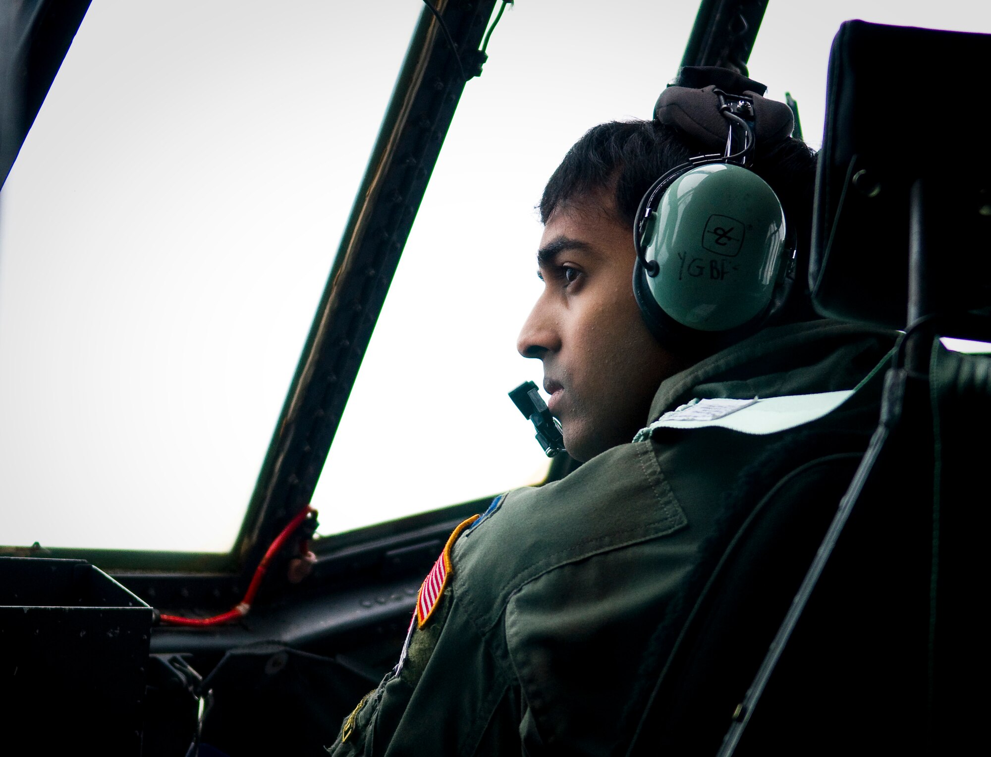 YOKOTA AIR BASE, Japan -- Capt. Yuri Batten, 36th Airlift Squadron pilot, looks out his side window to assess damage from the earthquake and tsunami March 22 while flying on a C-130H Hercules full of kerosene to Matsushima Air Base. The kerosene will be used to fuel heaters at relief shelters in northern Japan, where temperatures have repeatedly dropped below freezing. (U.S. Air Force photo/Staff Sgt. Chad Strohmeyer)