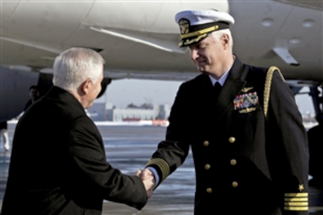 U.S. Navy Capt. Steve Krotow greets U.S. Defense Secretary Robert M. Gates upon his arrival at the Vnukovo International Airport in Moscow, March 22, 2011. Krotow is the naval attache for the U.S. Defense Attache Office in Moscow. 