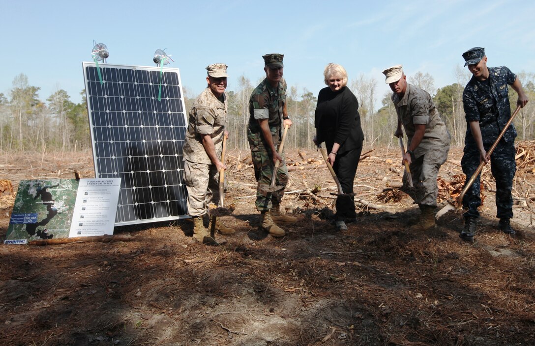 MARINE CORPS BASE CAMP LEJEUNE, N.C. – (From left to right) Col. Daniel Lecce, commanding officer for Marine Corps Base Camp Lejeune; Navy Capt. Craig Fulton, the director for Installations and Environment, MCB Camp Lejeune; Kay Lantrip, vice president and the project executive with URS Corporation and Navy Ensign David Dreyer, the project manager with the Officer In Charge of Construction, Marine Corps Installations East, perform the groundbreaking ceremony at the future sight of photo-voltaic panels that will provide energy to new barracks aboard Camp Johnson, March 23.