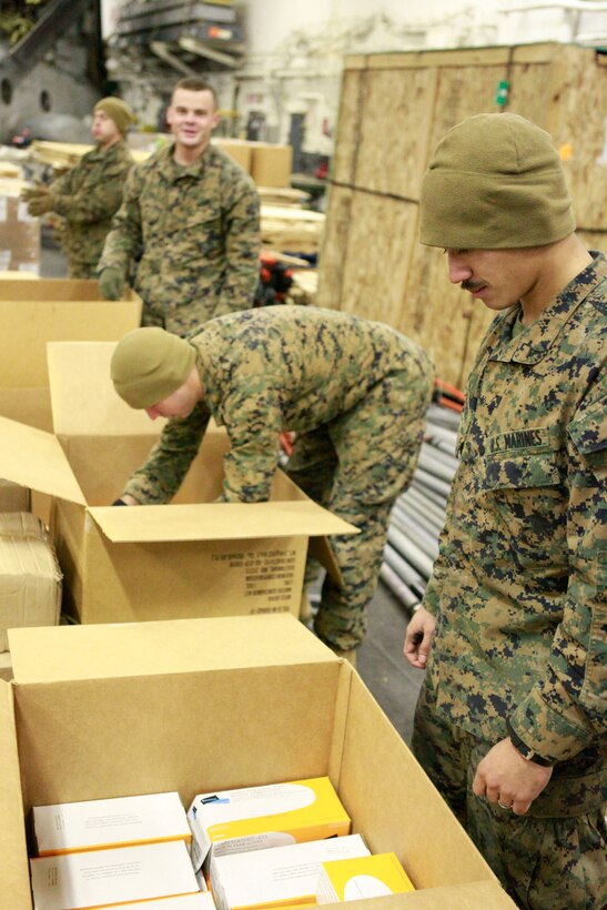 Marines with the 31st Marine Expeditionary Unit fill boxs with first aid supplies in the hanger bay aboard the forward deployed amphibious assault ship U.S.S. Essex (LHD-2), during Operation Tomodachi. Navy and Marine Corps involvement is part of a larger U.S. government response, coordinated with the government of Japan's ongoing relief efforts, after a 9.0 earthquake and subsequent tsunami struck Japan causing widespread damage. As part of Operation Tomodachi, the 31st MEU is ready to support our Japanese partners and to provide assistance when called upon.