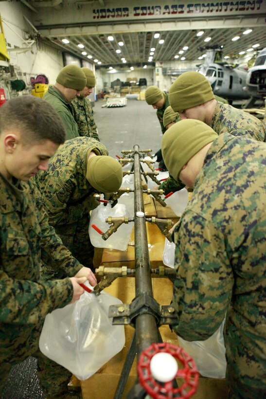 U.S. Marines with the 31st Marine Expeditionary Unit fill water jugs in the hanger bay aboard the forward deployed amphibious assault ship U.S.S. Essex (LHD-2), during Operation Tomodachi. Navy and Marine Corps involvement is part of a larger U.S. government response, coordinated with the government of Japan's ongoing relief efforts, after a 9.0 earthquake and subsequent tsunami struck Japan causing widespread damage. As part of Operation Tomodachi, the 31st MEU is ready to support our Japanese partners and to provide assistance when called upon.