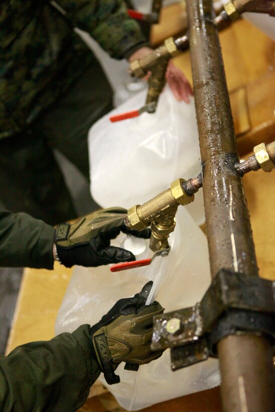 Marines with the 31st Marine Expeditionary Unit fill water jugs in the hanger bay aboard the forward deployed amphibious assault ship U.S.S. Essex (LHD-2), during Operation Tomodachi. Navy and Marine Corps involvement is part of a larger U.S. government response, coordinated with the government of Japan's ongoing relief efforts, after a 9.0 earthquake and subsequent tsunami struck Japan causing widespread damage. As part of Operation Tomodachi, the 31st MEU is ready to support our Japanese partners and to provide assistance when called upon.