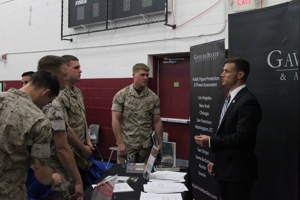 A representative from a personal sercurity services firm discusses employment opportunities with Marines during the Career and Education Fair at the West Gym and Fitness Center March 23, 2011.