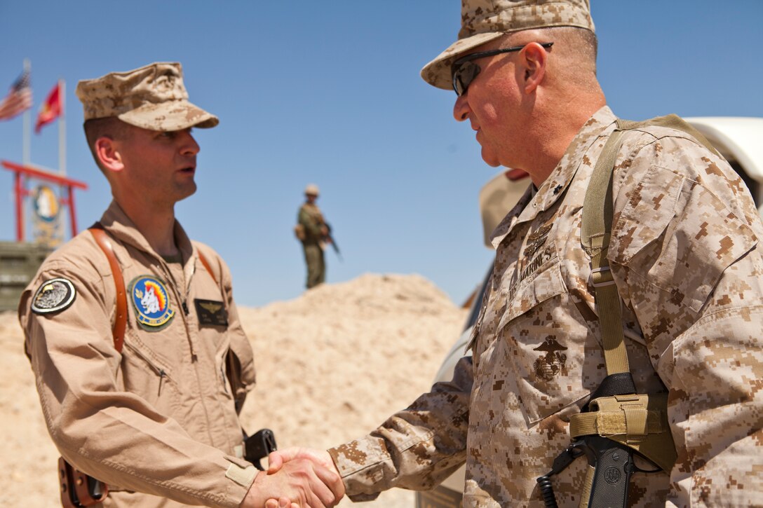 Brig. Gen. Glenn M. Walters shakes hands with Lt. Col. Scott W. Wadle following an awards ceremony at Camp Bastion, Afghanistan, March 23. Eight Marines from HMH-461 were awarded for participating in a tactical recovery of aircraft and personnel mission. Walters is the commanding general of 2nd Marine Aircraft Wing (Forward) and Wadle is the commanding officer of HMH-461