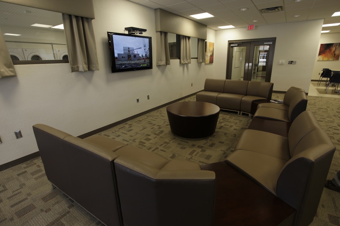 A seating area within a contemporary-styled lounge inside of Marine Corps Air Station Cherry Point's new bachelor enlisted quarters, which were unveiled during an official ribbon-cutting ceremony at the air station March 25. The lounge features three 55” flat-screen TVs, a slate pool table, wireless internet and an eating area with a conventional oven and full-sized fridge.