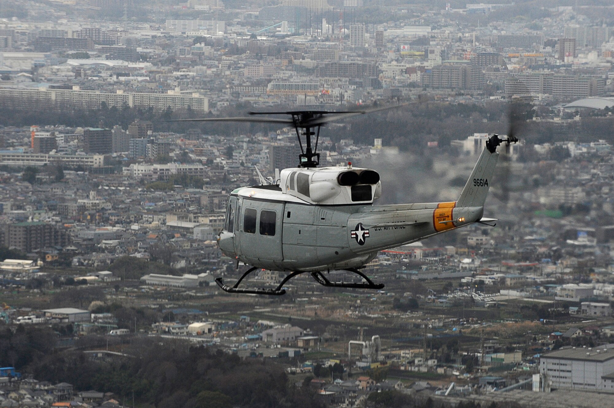 YOKOTA AIR BASE, Japan -- A UH-1 Huey helicopter flies over Japan, March 23, 2011. The helicopters are critical in providing logistical support by transporting general officers, Department of Energy personnel and other officials in support of Operation Tomodachi. (U.S. Air Force photo/Master Sgt. Jeromy K. Cross/released)




