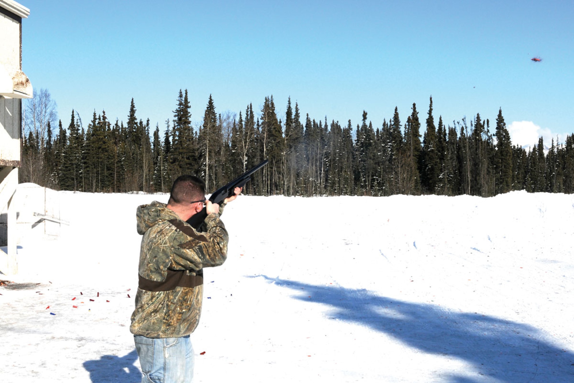 Tech. Sgt. David Gunn, 354th Security Forces Squadron Eielson Air Force Base, Alaska, hits a clay pigeon March 18, during a round of skeet at the range on Joint Base Elmendorf-Richardson. Shooting results are tallied weekly for the year-long competition. (U.S. Air Force photo/Steve White)