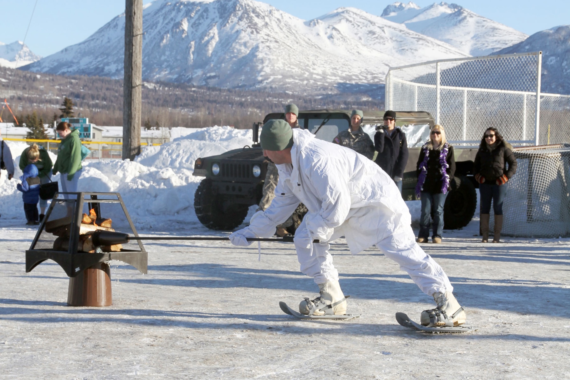 Spc. Christopher Salinas, of Headquarters and Headquarters Company, 6th Engineer Battalion, lights the Arctic Sapper Winter Olympic Games fire March 14, signifying the start of the games. (U.S. Army photo/Staff Sgt. Jason Epperson)