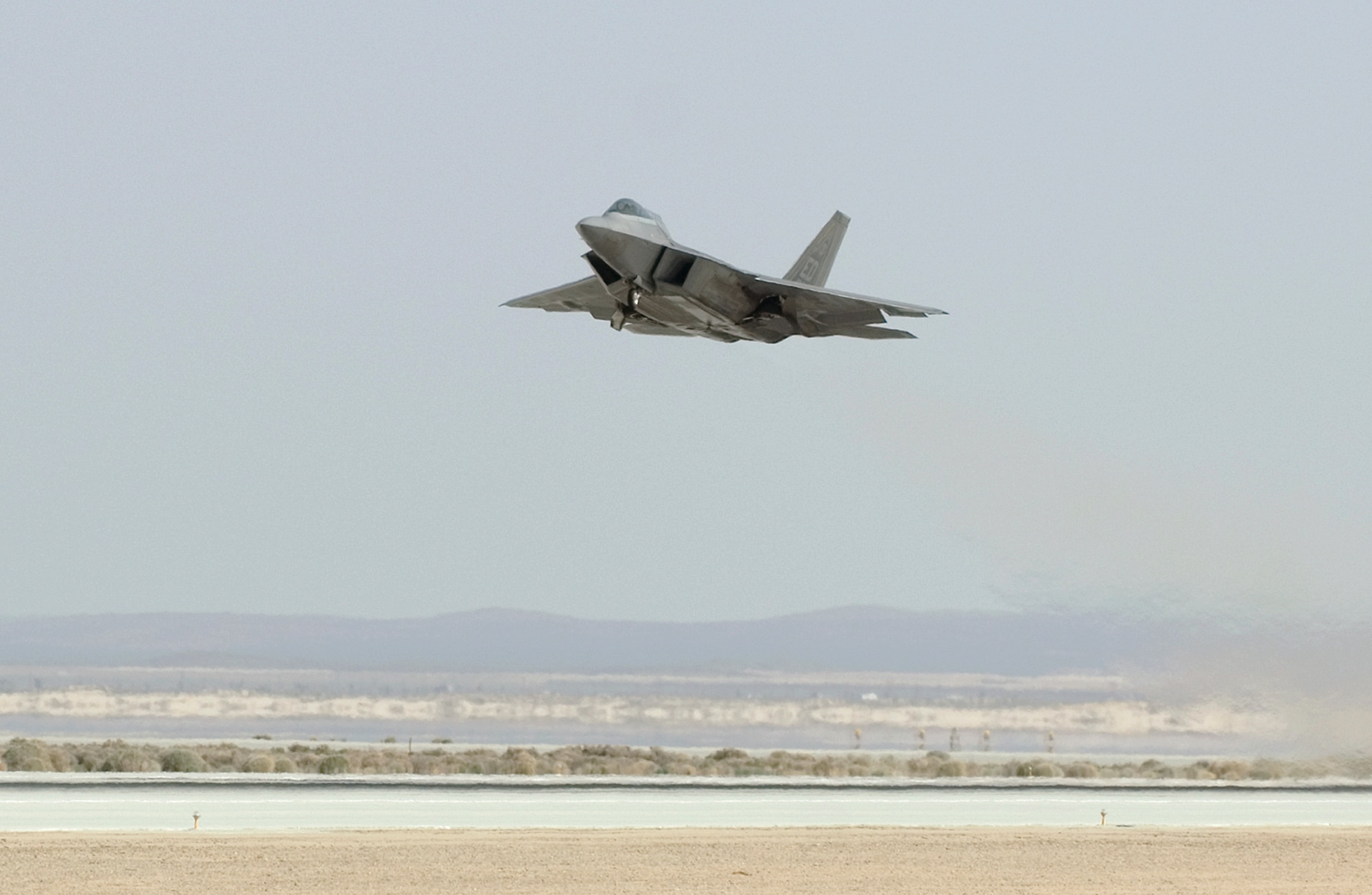 An F-22 Raptor powered by biofuel takes off March 18, 2011, at Edwards Air Force Base, Calif. The flight was the capstone of a series of ground and flight test events conducted by members of the 411th Flight Test Squadron for the F-22, using the biofuel blend. (U.S. Air Force photo/Kevin North)