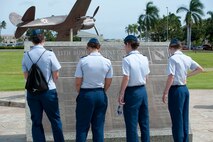 Cadets from the U.S. Air Force Academy read the historical plaques on display Mar. 21 in Atterbury Circle at Joint Base Pearl Harbor Hickam, Hawaii. The 15th Wing hosted the cadets from the "Fightin' Fourth" squadron at Peterson Air Force Base, Colo. during their week-long visit to the base. (U.S. Air Force photo/Staff Sgt. Nathan Allen)