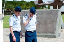 Cadets 2nd Class Alexa Ramsier and Bridgett Murphy from the U.S. Air Force Academy read the historical plaques on display Mar. 21 in Atterbury Circle at Joint Base Pearl Harbor Hickam, Hawaii. The 15th Wing hosted the cadets from the "Fightin' Fourth" squadron at Peterson Air Force Base, Colo. during their week-long visit to the base. (U.S. Air Force photo/Staff Sgt. Nathan Allen)