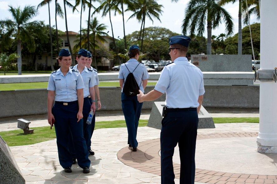 1st Lt. Jason Smith, 15th Wing Public Affairs deputy chief, discusses 15th Wing history with U.S. Air Force Academy cadets Mar. 21 in Atterbury Circle at Joint Base Pearl Harbor Hickam, Hawaii. The 15th Wing hosted the cadets from the "Fightin' Fourth" squadron at Peterson Air Force Base, Colo. during their week-long visit to the base. (U.S. Air Force photo/Staff Sgt. Nathan Allen)
