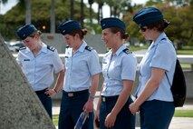 Cadets from the U.S. Air Force Academy read the historical plaques on display Mar. 21 in Atterbury Circle at Joint Base Pearl Harbor Hickam, Hawaii. The 15th Wing hosted the cadets from the "Fightin' Fourth" squadron at Peterson Air Force Base, Colo. during their week-long visit to the base. (U.S. Air Force photo/Staff Sgt. Nathan Allen)