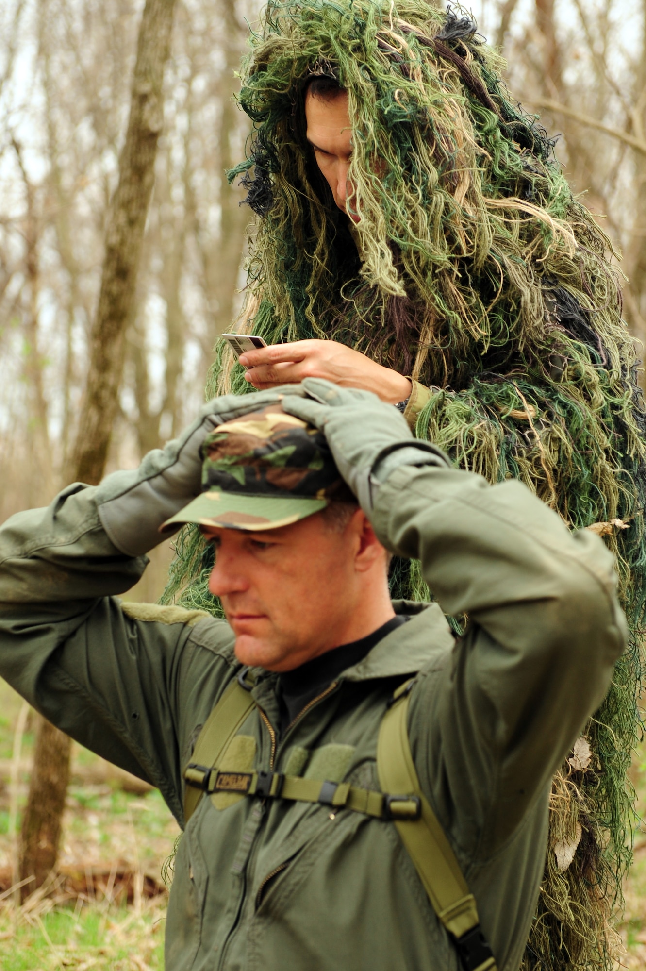 Tech. Sgt. Robert Graham, 375th Operations Support Squadron S.E.R.E specialist verifies the identity of a downed aircrew member during  Combat Survival Training at the Illinois Army National Guard’s Sparta Training Area, Sparta, Ill. on March 22, 2011. For the safety of military members who’s plane could crash, they are trained to sanitize their uniforms, removing all military patches, ranks, insignias and name tapes. During training aircrew members are required to wear an ABU or BDU cap.(U.S. Air Force photo by Staff Sgt. Teresa M. Jennings)