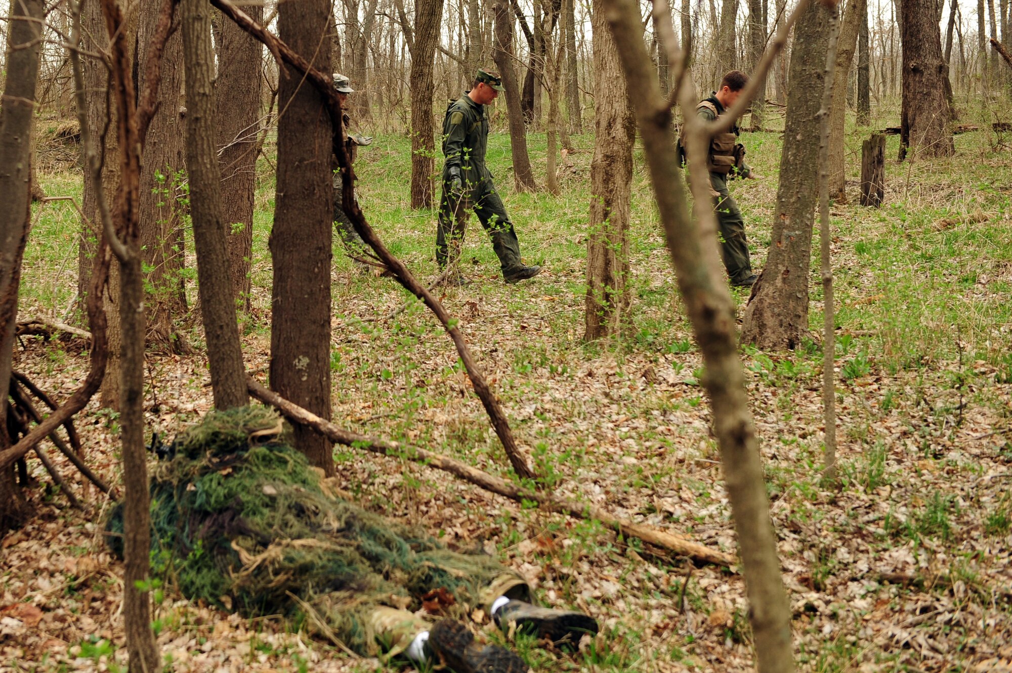 Tech. Sgt. Robert Graham, 375th Operations Support Squadron S.E.R.E specialist watches as aircrew who requested extraction make their way to their rally point during  Combat Survival Training at the Illinois Army National Guard’s Sparta Training Area, Sparta, Ill. on March 22, 2011. S.E.R.E instructors train aircrew on the basic to advanced techniques of  survival, evasion, resistance, and escape. During training aircrew members are required to wear an ABU or BDU cap. (U.S. Air Force photo by Staff Sgt. Teresa M. Jennings)