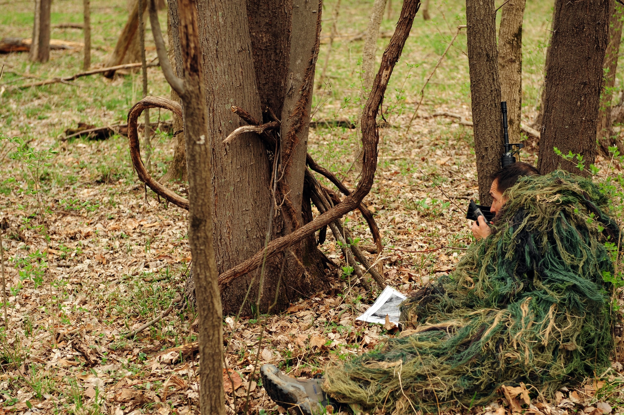 Tech. Sgt. Robert Graham, 375th Operations Support Squadron S.E.R.E specialist communicates with aircrew requesting extraction from an unknown location after their plane crashed  during  Combat Survival Training at the Illinois Army National Guard’s Sparta Training Area, Sparta, Ill. on March 22, 2011. Students had refresher training in land navigation, camouflage techniques, methods of evasion, and communication protocols. (U.S. Air Force photo by Staff Sgt. Teresa M. Jennings)