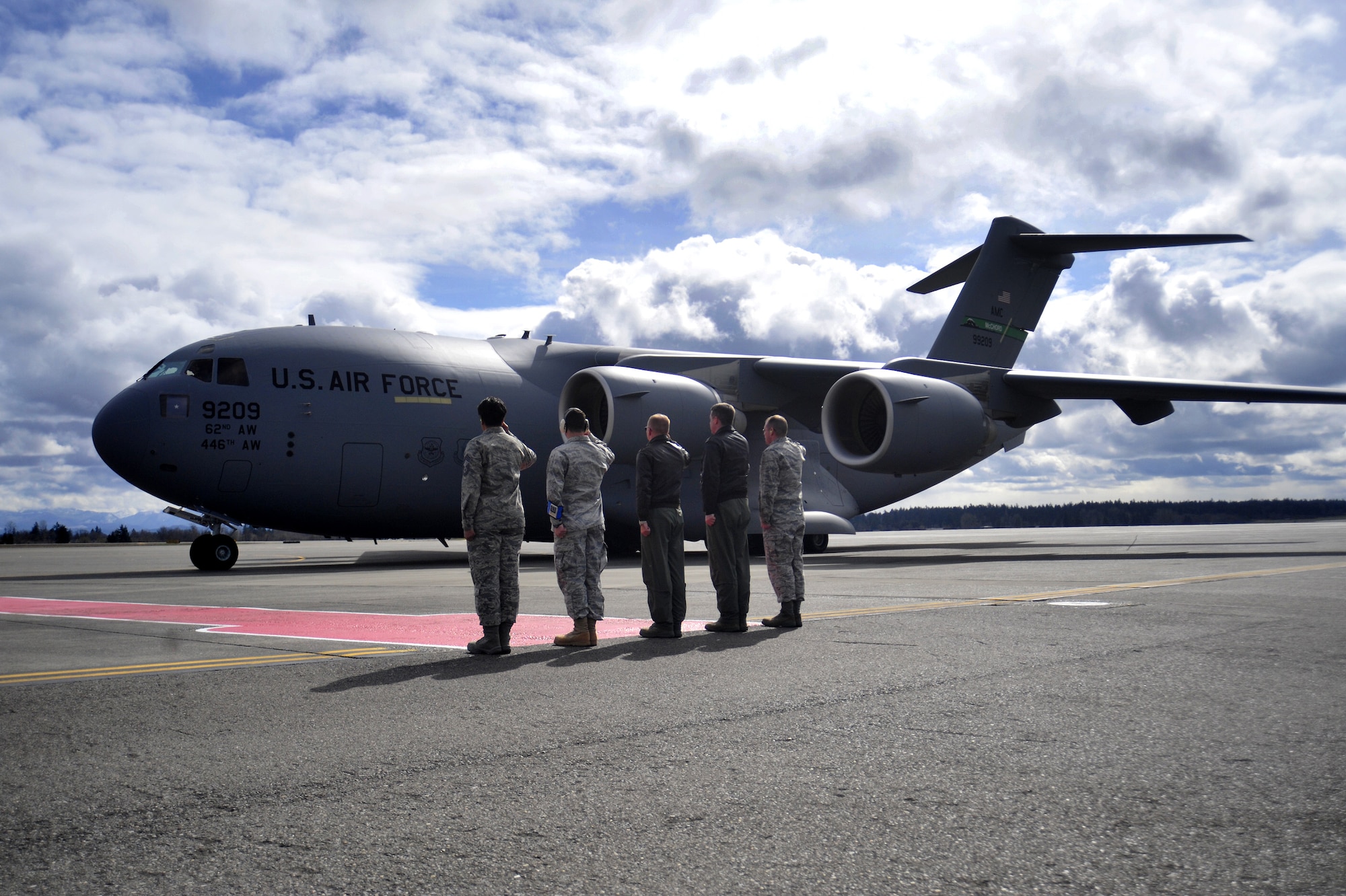 Leaders from the 62nd Airlift Wing salute McChord Field’s newest C-17 Globemaster III as it taxis down the runway March 22, 2011, at Joint Base Lewis-McChord, Wash. (U.S. Air Force photo/Airman 1st Class Leah Young)