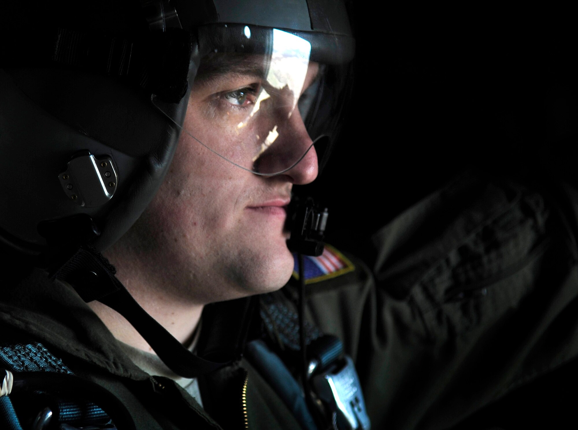 Airman 1st Class Austin Koester relays information to pilots of a C-130J Super Hercules as static line paratroopers prepare to exit for a jump March 18, 2011, over a landing zone near Campia Turzii, Romania. This jump was conducted as part of Carpathian Spring 2011, an exercise where members of the U.S. military joined their Romanian counterparts to learn from one another and strengthen alliances. Airman Koester is a loadmaster assigned to the 37th Airlift Squadron. (U.S. Air Force photo/Tech. Sgt. Jocelyn L. Rich)