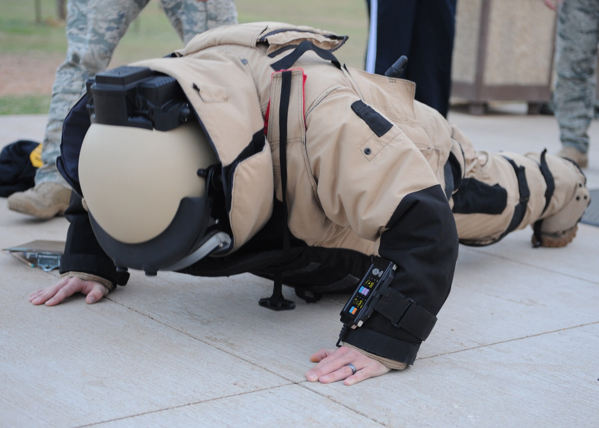 DYESS AIR FORCE BASE, Texas—Senior Airman Joseph Fairchild, 7th Explosive Ordinance Disposal Unit, does push-ups in an EOD 9 Bomb Suit March 22 during a two-part training exercise here. The first part involved removing their flak vest while underwater, swimming 25 meters and rescuing each other from the water.  The second part involved push-ups, putting together a pan disrupter and carrying it a quarter-mile, all while wearing an 85-pound bomb suit on the track outside of the fitness center.  EOD conducts training everyday so their Airmen are prepared for challenges they may face. (U.S. Air Force photo/ Airman 1st Class Shannon Hall)