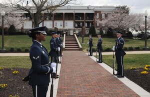 Members of the Air Force Honor Guard await the arrival of the official party at the 11th Operations Group assumption of command ceremony on Joint Base Anacostia-Bolling  March 22.  Colonel Gina Humble assumed command of the 11 OG, which oversees the the Air Force Honor Guard, Band and Arlington Chaplaincy. (U.S. Air Force photo by Senior Airman Torey Griffith)