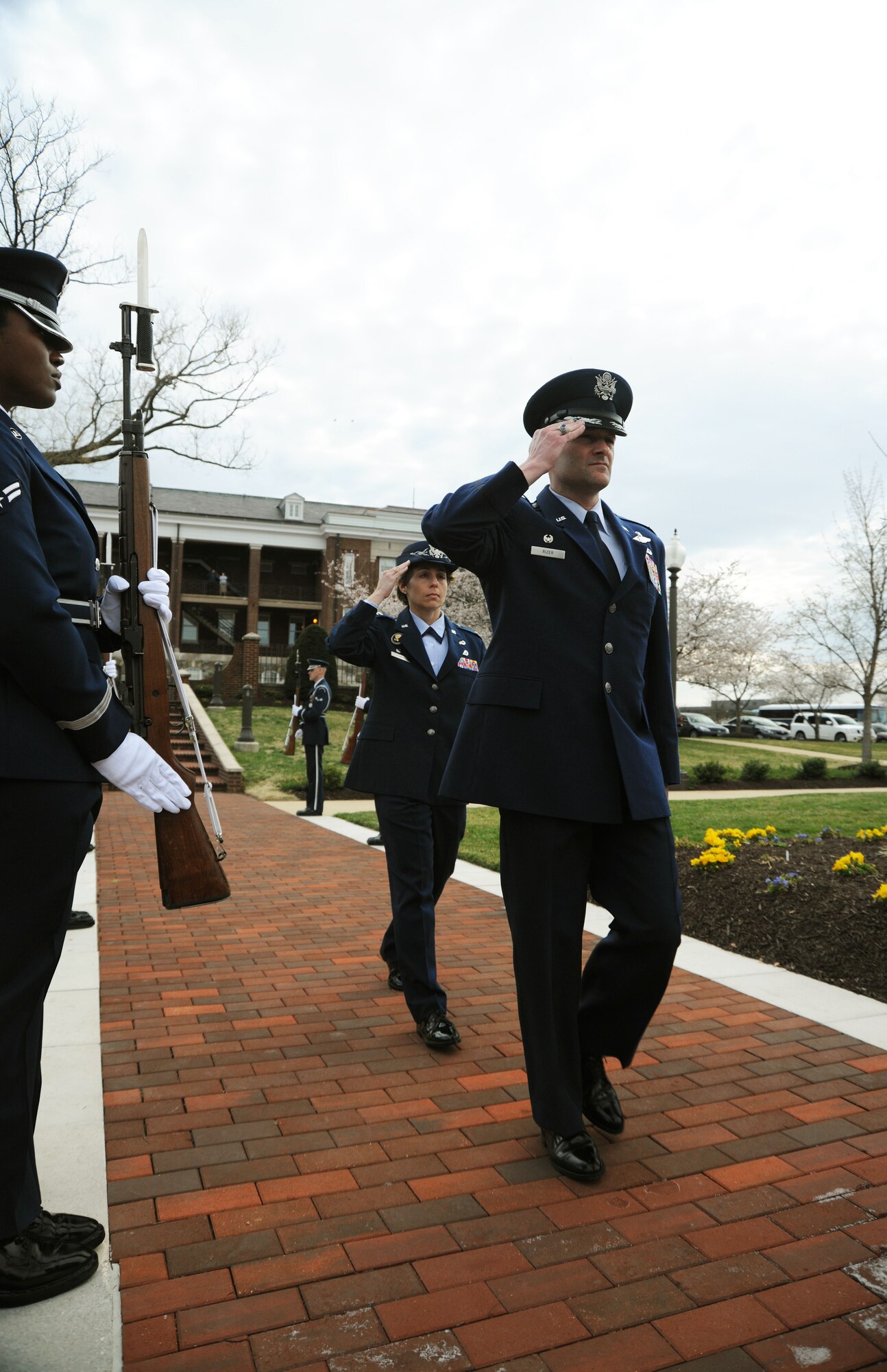 Colonel Ken Rizer, 11th Wing/Joint Base Andrews commander, and Col. Gina Humble, 11 Operations Group commander, salute members of the Air Force Honor Guard as they arrive at the assumption of command ceremony on Joint Base Anacostia-Bolling March 22. Colonel Gina Humble assumed command, and will lead the group "to a higher level of excellence." (U.S. Air Force photo by Senior Airman Torey Griffith)