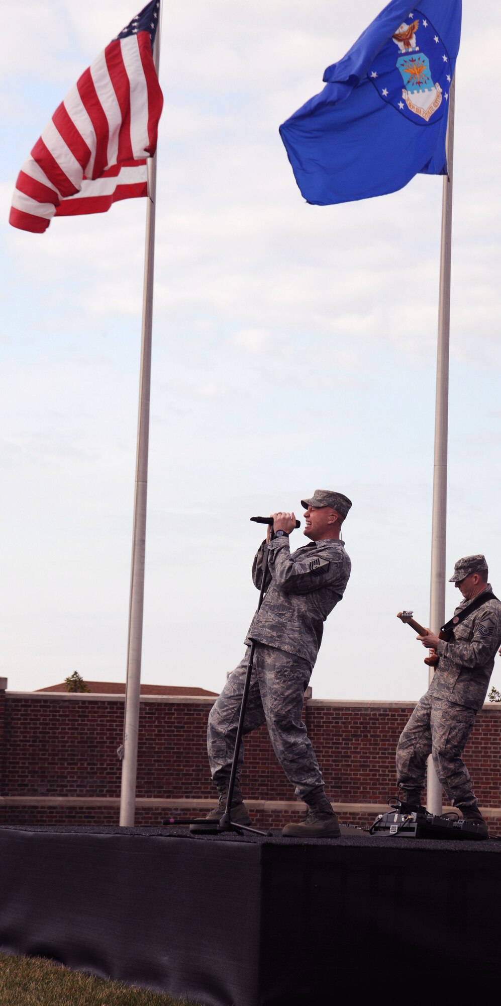 Master Sgt. Ryan Carson, lead singer of the Air Force Band's rock specialists, Max Impact, belts out the lyrics to "Send Me," a song written about the American Airman.  Max Impact entertained attendees at Col. Humble's assumption of command ceremony March 22. (U.S. Air Force photo by Senior Airman Torey Griffith)