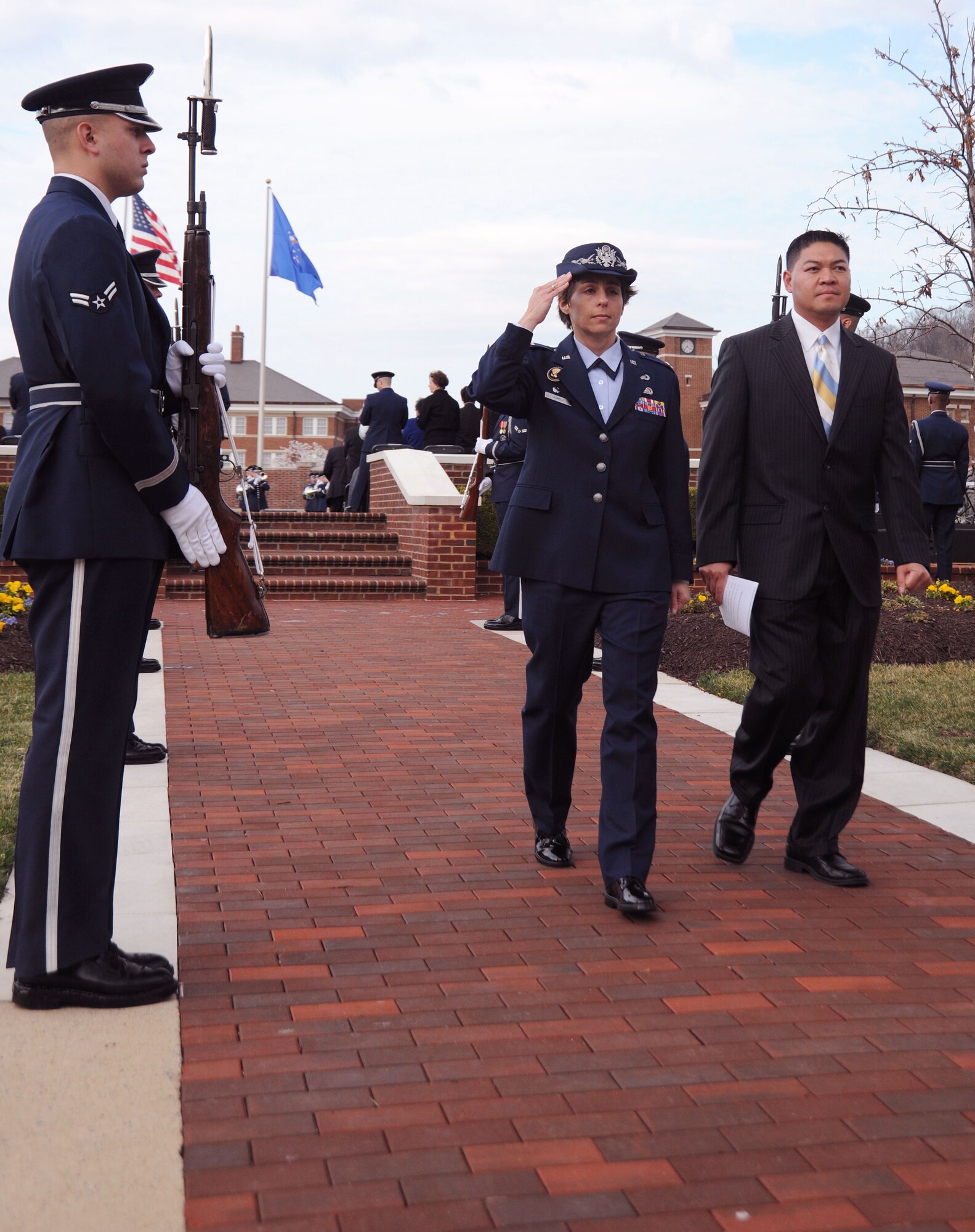 Colonel Gina Humble salutes members of the Air Force Honor Guard as she departs her 11th Operations Group assumption of command ceremony on Joint Base Anacostia-Bolling March 22.  The 11th Operations Group oversees several prestigious organizations such as the Air Force Honor Guard and the Air Force Band, both of which display the Air Force's pride and dedication to perfection worldwide. (U.S. Air Force photo by Senior Airman Torey Griffith)