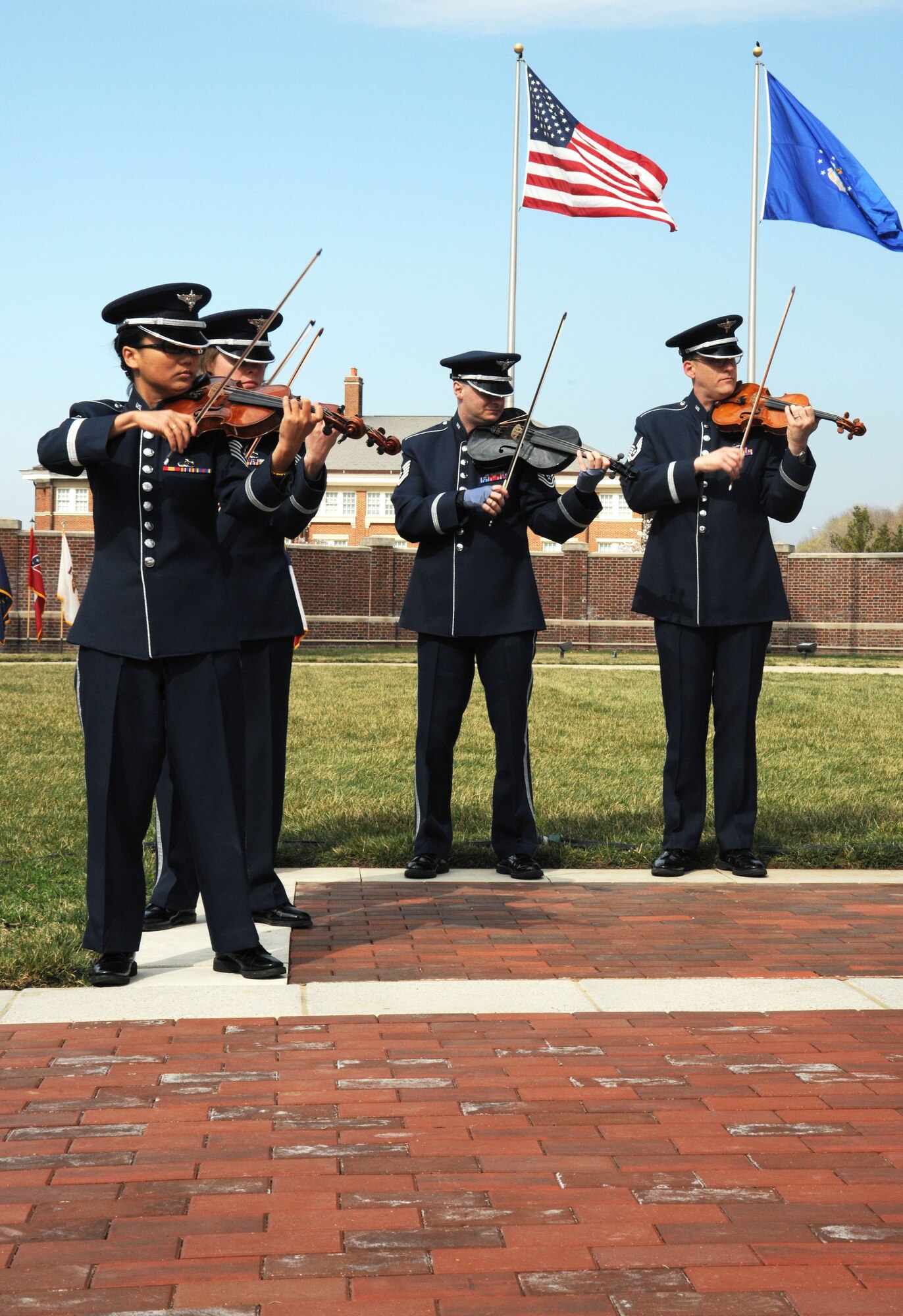 Members of the The United States Air Force Strolling Strings entertain attendees at the 11th Operations Group assumption of command ceremony on Joint Base Anacostia-Bolling March 22.  Colonel Gina Humble assumed command of the distinguished group that includes the Air Force Honor Guard, the Air Force Band and the Arlington Chaplaincy. (U.S. Air Force photo by Senior Airman Torey Griffith)