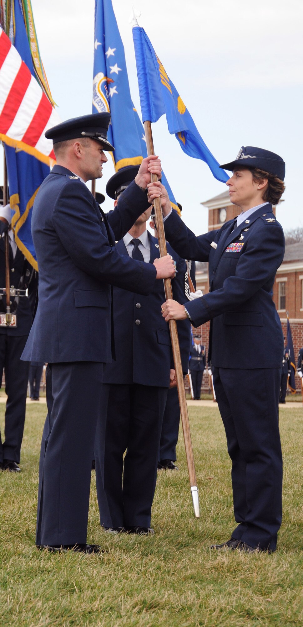 Colonel Gina C. Humble takes the guidon from Col. Ken Rizer, 11th Wing/Joint Base Andrews commander, assuming command of the 11th Operations Group in a ceremony on Joint Base Anacostia-Bolling March 22. Colonel Humble comes to the 11th Wing with a distinguished record of service, and extensive education, including three master's degrees. (U.S. Air Force photo by Senior Airman Torey Griffith)