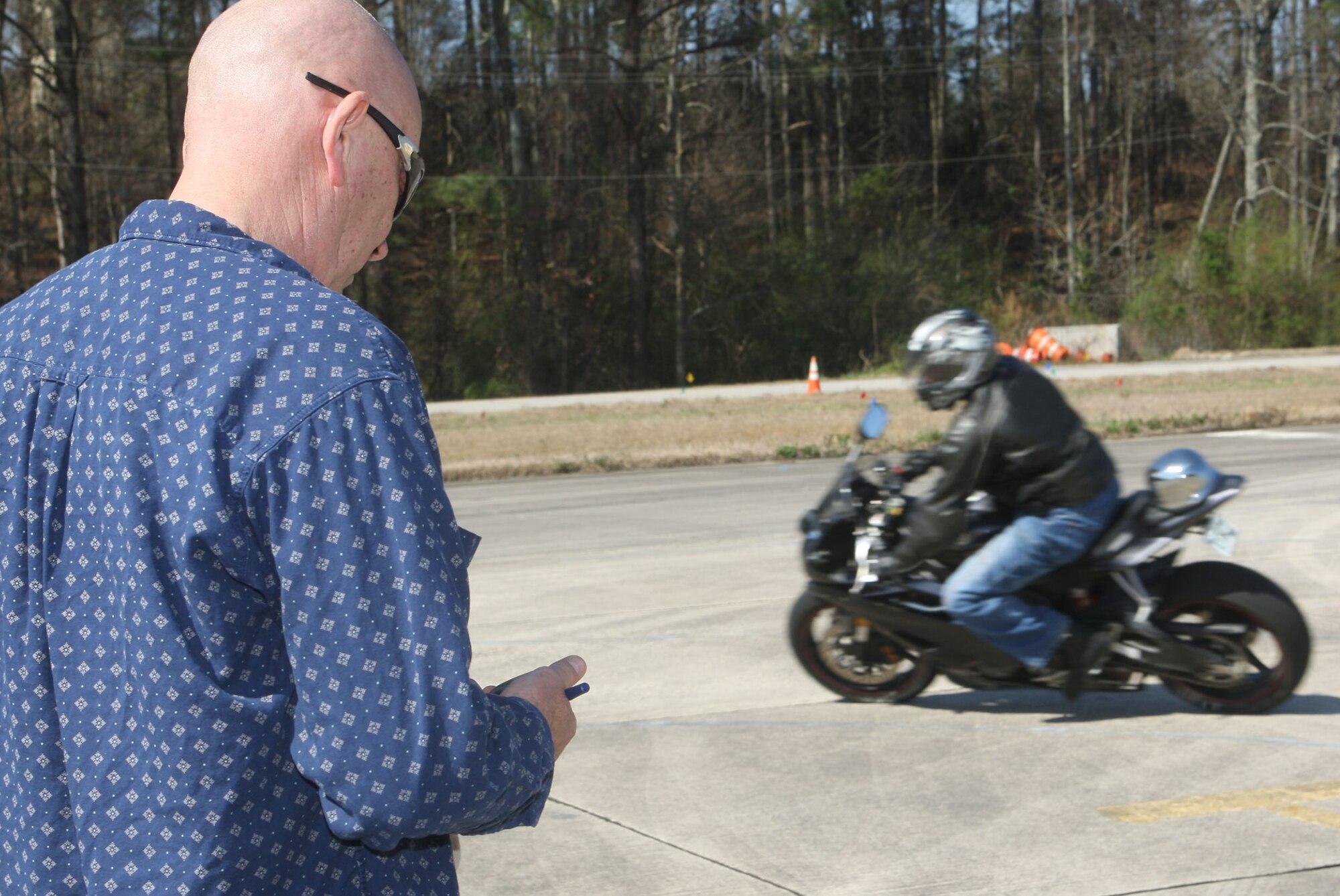 Rider coach Senior Master Sgt. Earl Davis observes a riders time during a practical evaluation Mar 17. (U.S. Air Force Photo/Don Peek)