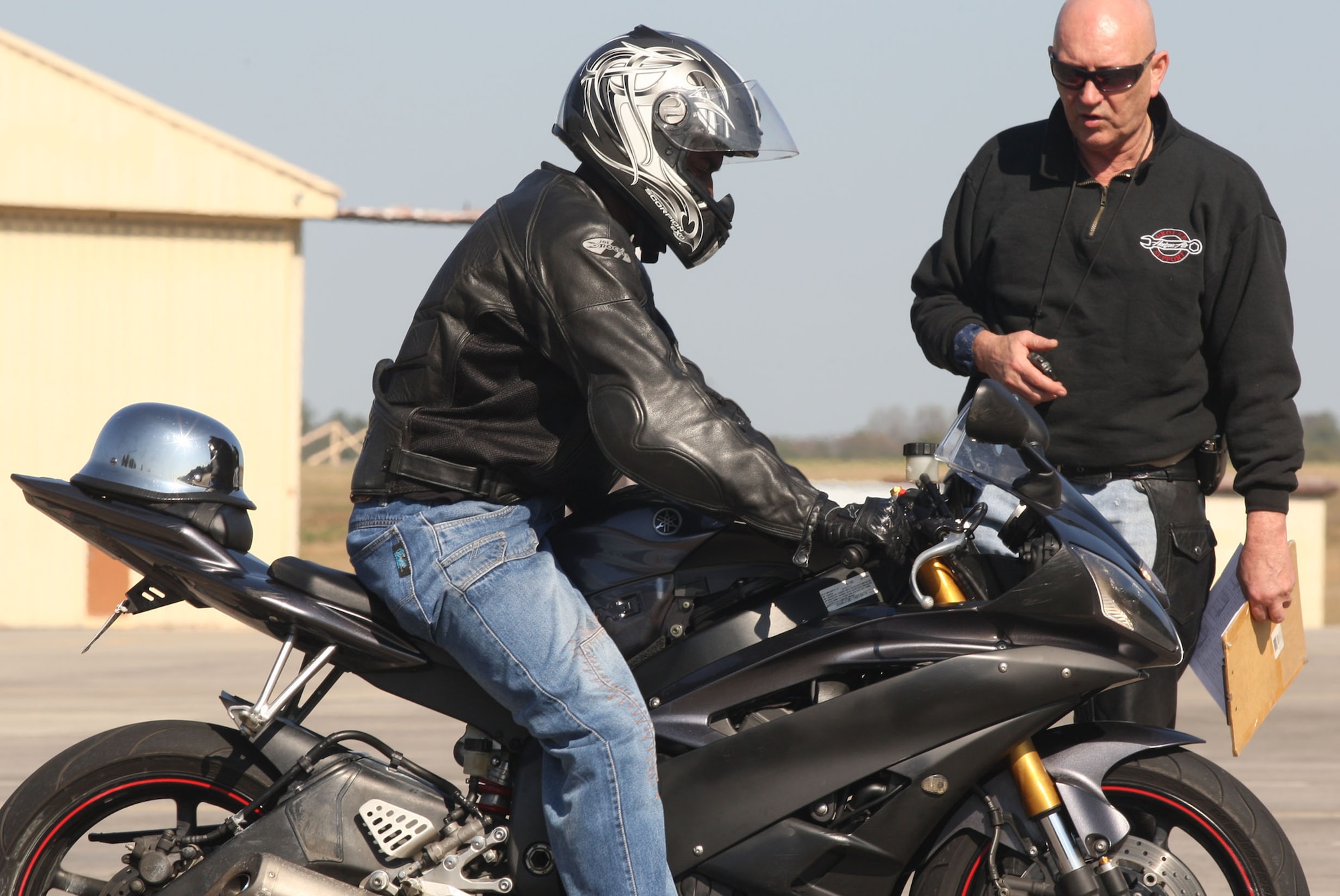 Rider coach Senior Master Sgt. Earl D. Davis gives advice on the stopping distance exercise during training on the motorcycle range Mar 17. U.S. Air Force Photo/Don Peek)