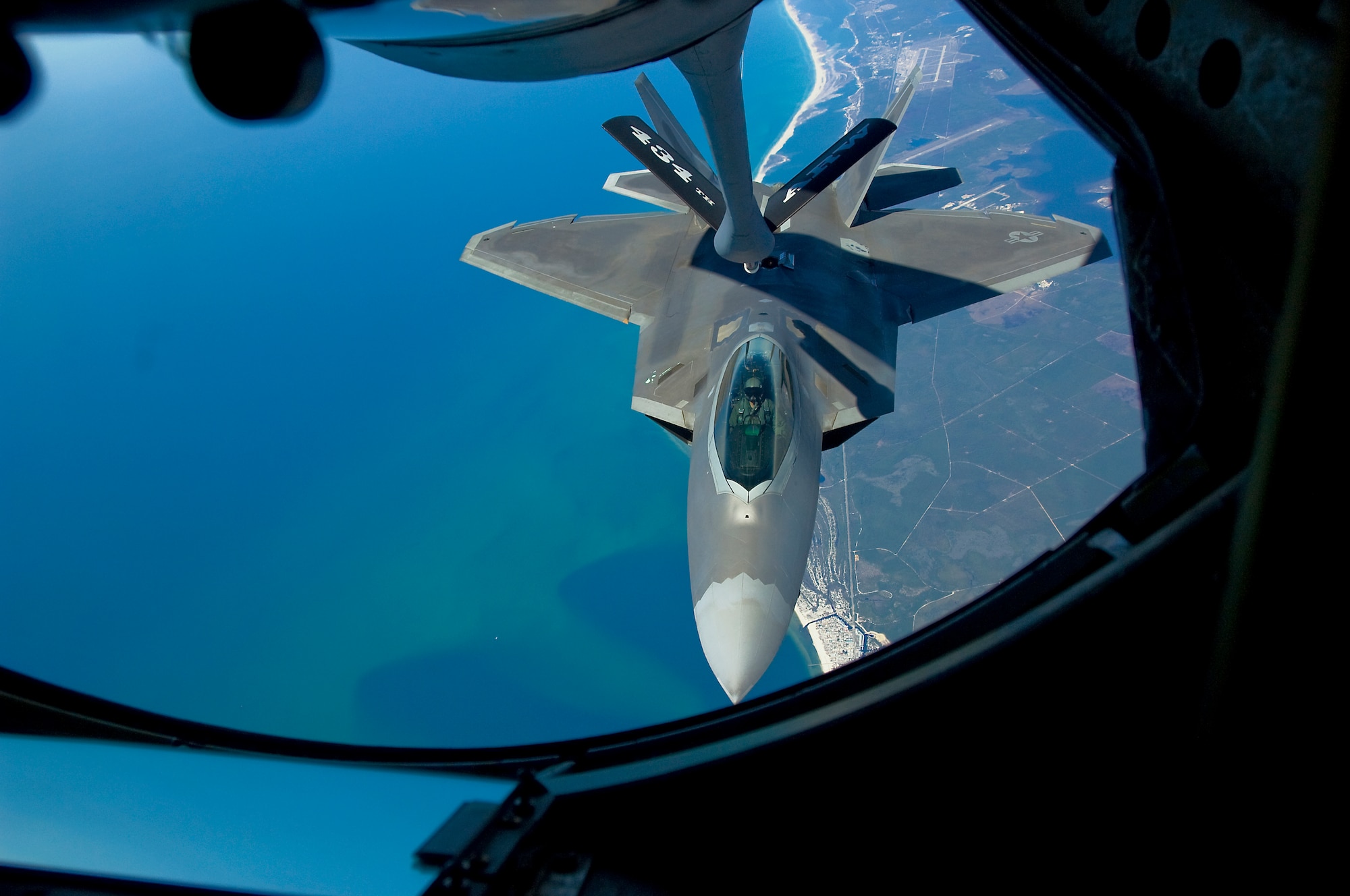 GRISSOM AIR RESERVE BASE, Ind. -- An F-22 Raptor from the 325th Fighter Wing prepares to connect to a KC-135 Stratotanker refueling boom over Florida March 18. Aerial refueling acts as a force multiplier for aircraft, allowing them to stay airborne longer and extending their reach. The KC-135 is from the 434th Air Refueling Wing at Grissom Air Reserve Base, Ind., which is the largest KC-135 unit in the Air Force Reserve Command. (U.S. Air Forcephoto/Senior Airman Damon Kasberg)