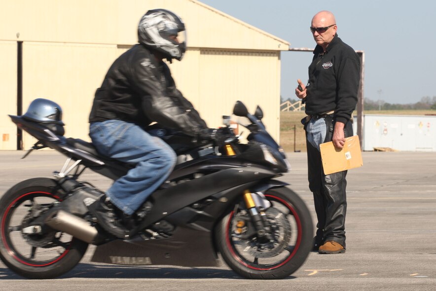 Rider coach Senior Master Sgt. Earl D. Davis observes riders during the stopping distance exercise on the motorcycle range Mar 17. U.S. Air Force Photo/Don Peek)