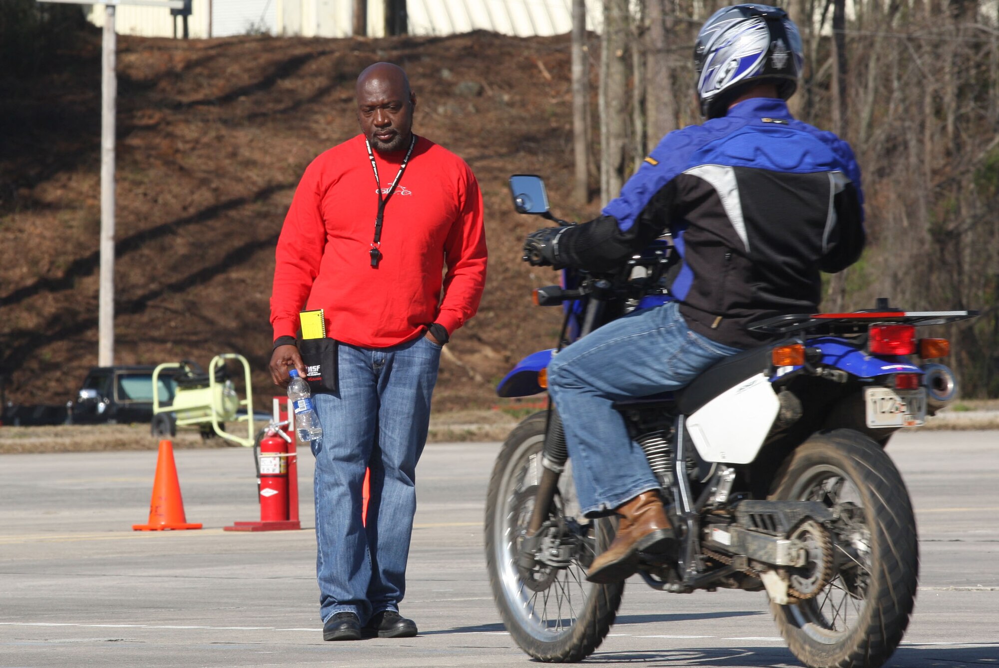 Rider coach Mark Daniel observe a rider as he maneuvers through one of the numerous motorcycle range course configurations Mar 16. (U.S. Air Force Photo/Don Peek)