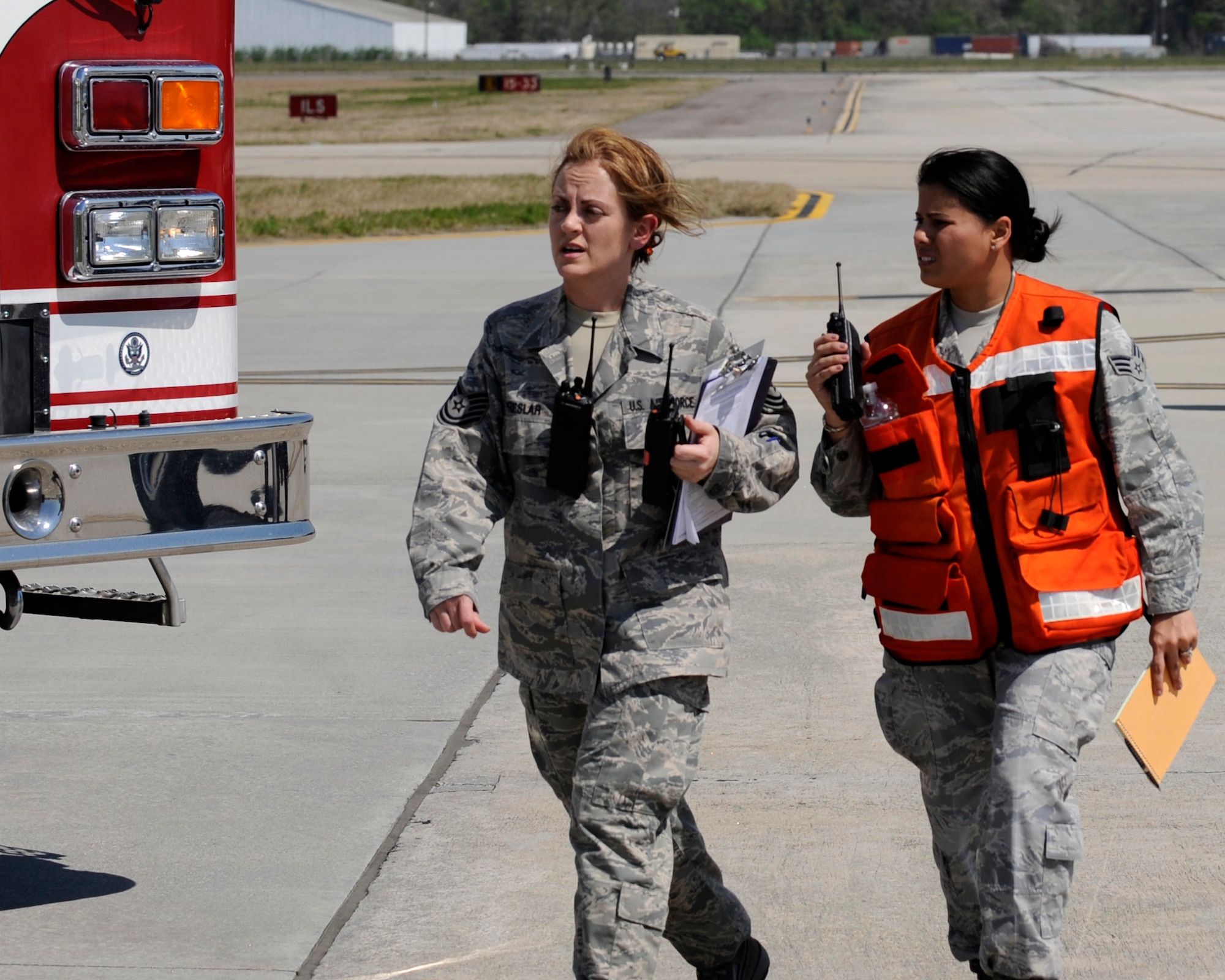 Tech Sgt. Cristy Preslar and Senior Airman Imelda Corvetto, discuss patient care during a Major Accident Response Exercise (MARE), March 22, 2011 on Joint Base Charleston, S.C. The MARE is a necessary step to prepare all Joint Base Charleston members for the upcoming 2011 Air Expo. The exercise is used to help test and train the supporting agencies who would respond in case of an emergency. TSgt Preslar and SrA Corvetto are both assigned to the 628th Medical Group.  (U.S. Air Force photo by Staff Sgt Jared Becker)(Released)