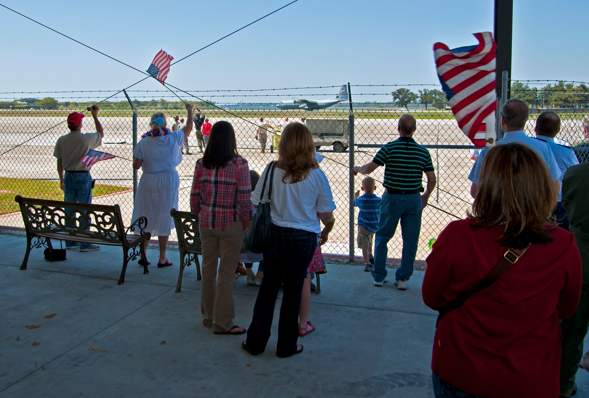 Family members await loved ones and cheer an the 815th Airlift Squadron C-130J-30 returns to the 403rd Wing, Keesler Air Force Base, Miss., from Southwest Asia March 21.  Reservists from the 403rd Wing deployed in January 2011 to support overseas contingency operations there.  (U.S. Air Force photo by Tech. Sgt. Tanya King)