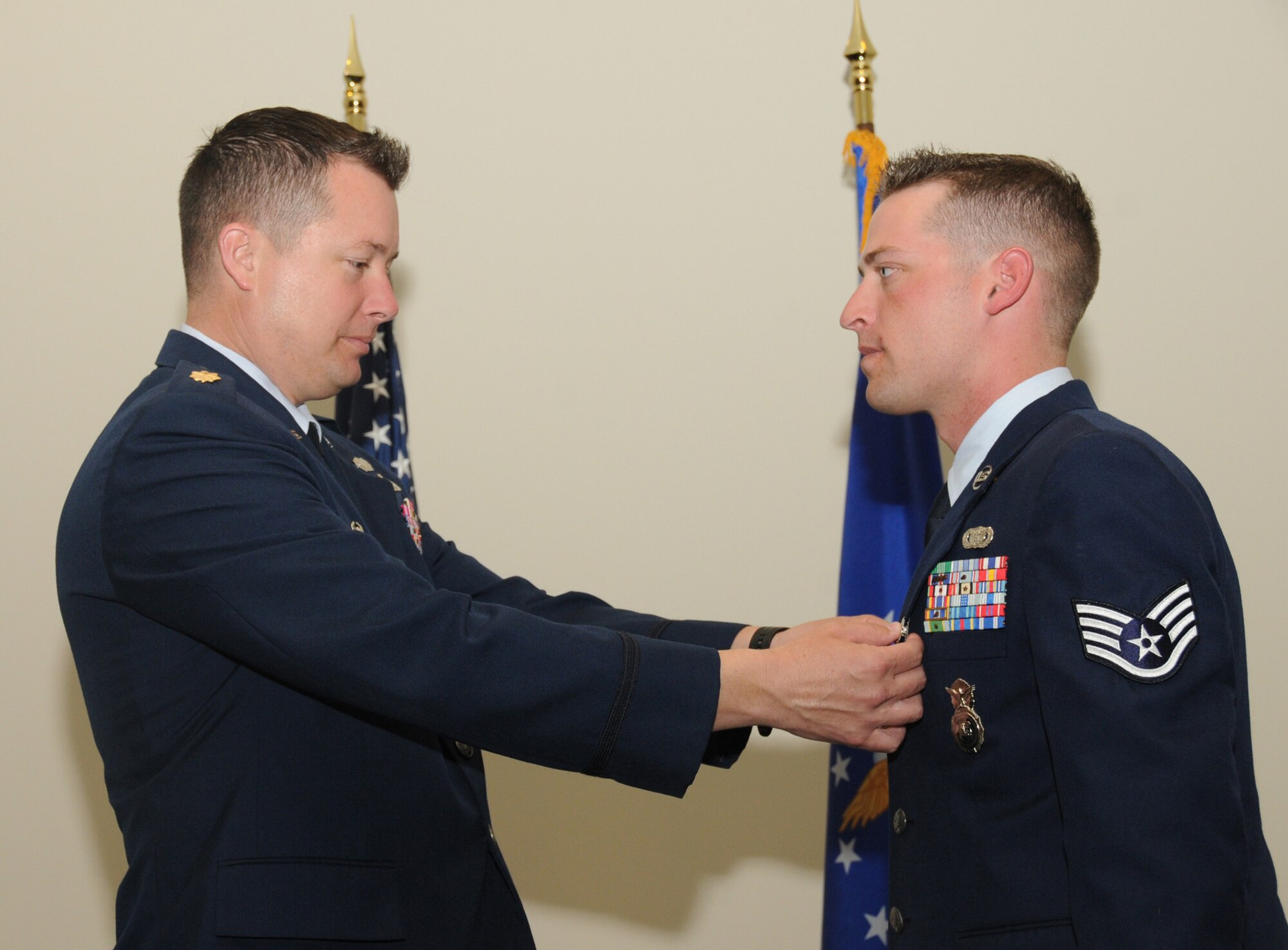 Major Clark pins a Purple Heart medal on Sergeant Martin’s uniform during the March 18 ceremony.  (U.S. Air Force photo by Kemberly Groue)