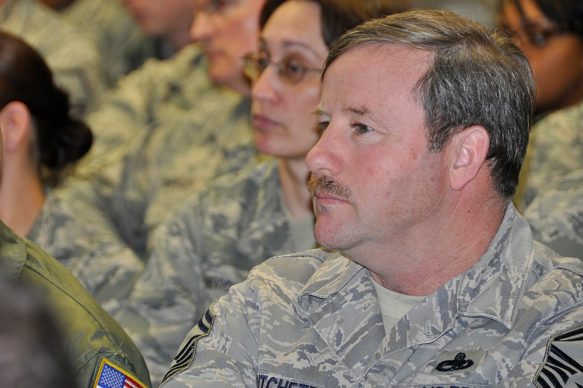 JOINT BASE MCGUIRE-DIX-LAKEHURST, N.J. -- Senior Master Sgt. Carey Pritchett, 514th Air Mobility Operations Squadron, listens to a presentation about the wing’s recent inspections in an auditorium within the 514th Aeromedical Evacuation Squadron here March 22, 2011. The wing earned high marks in the unit compliance inspection, the logistics compliance assessment program and the aircraft standardization evaluation visit. (U.S. Air Force photo/Tech. Sgt. Shawn J. Jones) 