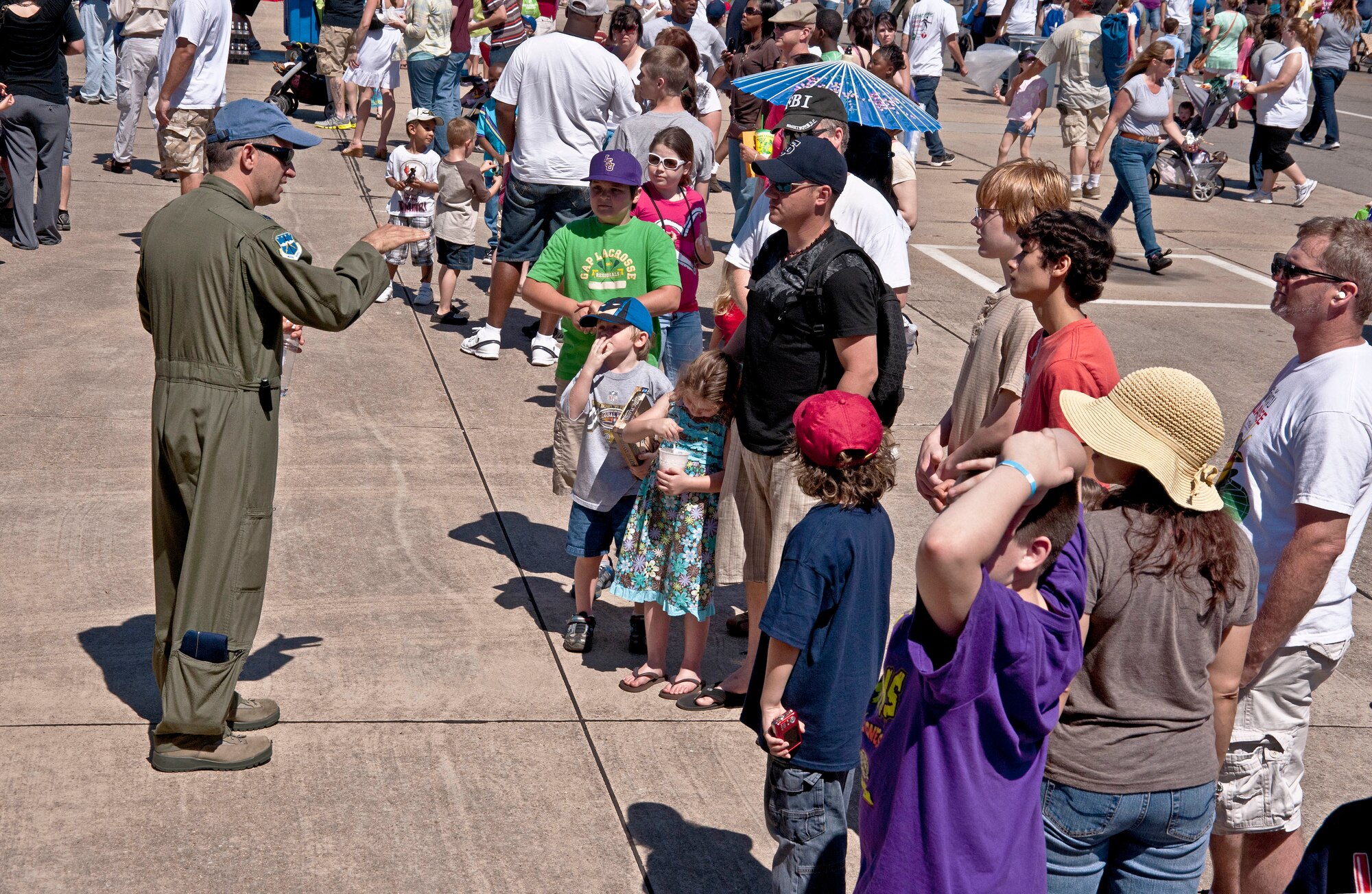 Lt. Col. Jeff Ragusa, 53rd Weather Reconnaissance Squadron pilot, speaks to throngs of air show attendees as they wait to tour a static display of a WC-130J "Hurricane Hunter" at Keesler Air Force Base, Miss.  Reservists from the 403rd Wing educated the public about the various missions they are responsible for here. More than 160,000 people attended the biannual event here March 19-20.  