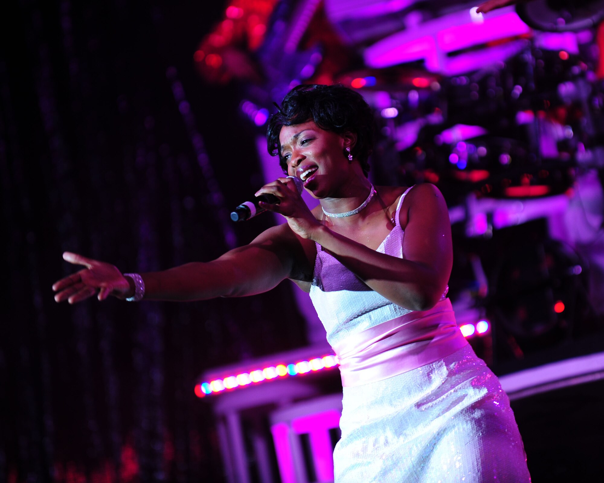 DAVIS-MONTHAN AIR FORCE BASE, Ariz. - Senior Airman Megan Harvey, a vocalist in the Air Force’s Tops in Blue performance group, belts out a solo during a show at the Tucson Convention Center in Tucson, Ariz., March 20. Comprised of 35 of the Air Force’s most talented vocalists and musicians, the group performs for Airmen and their families worldwide. (U.S. Air Force photo/Airman 1st Class Jerilyn Quintanilla)