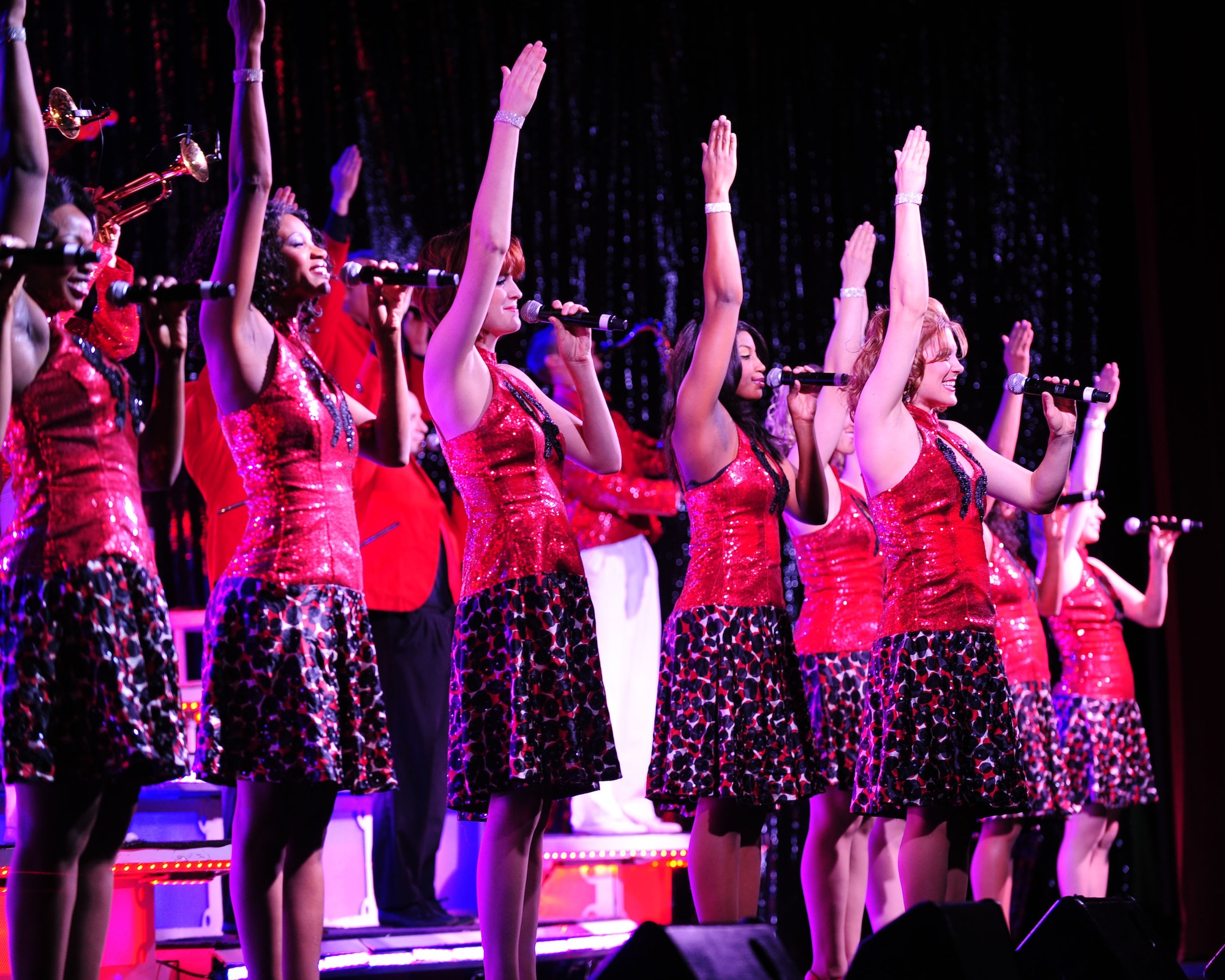 DAVIS-MONTHAN AIR FORCE BASE, Ariz.- Vocalists of the of the Air Force’s Tops in Blue performance group, perform in front of more than 800 people at the Tucson Convention Center in Tucson, Ariz., March 20. Founded in the 1950s, the group puts on more than 100 shows during their tour. The 2011 show entitled “We Believe,” featured songs by various artists including Lady Gaga, the Black Eyed Peas and Journey. (U.S. Air Force photo/Airman 1st Class Jerilyn Quintanilla)