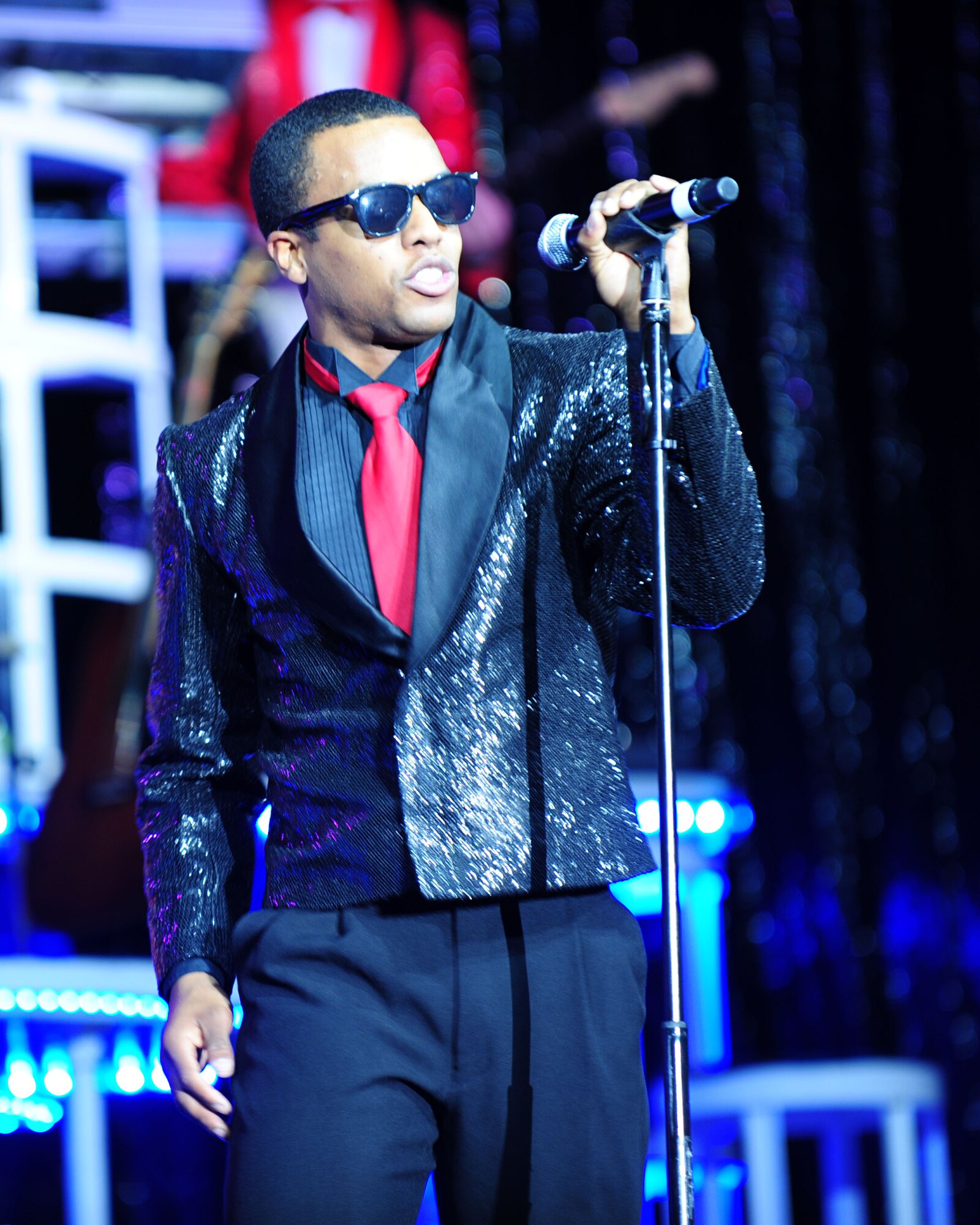 DAVIS-MONTHAN AIR FORCE BASE, Ariz. - Capt. John Early, vocalist for the Air Force’s Tops in Blue performance group, performs during a concert at the Tucson Convention Center in Tucson, Ariz., March 20. The group performed a wide range of music to include old favorites by Michael Jackson and Ray Charles and current radio hits by Lady Gaga and the Black Eyed Peas. For the past 55 years, Tops in Blue has served as the Air Force’s expeditionary entertainment unit providing entertainment to Airmen across the world. (U.S. Air Force photo/Airman 1st Class Jerilyn Quintanilla)