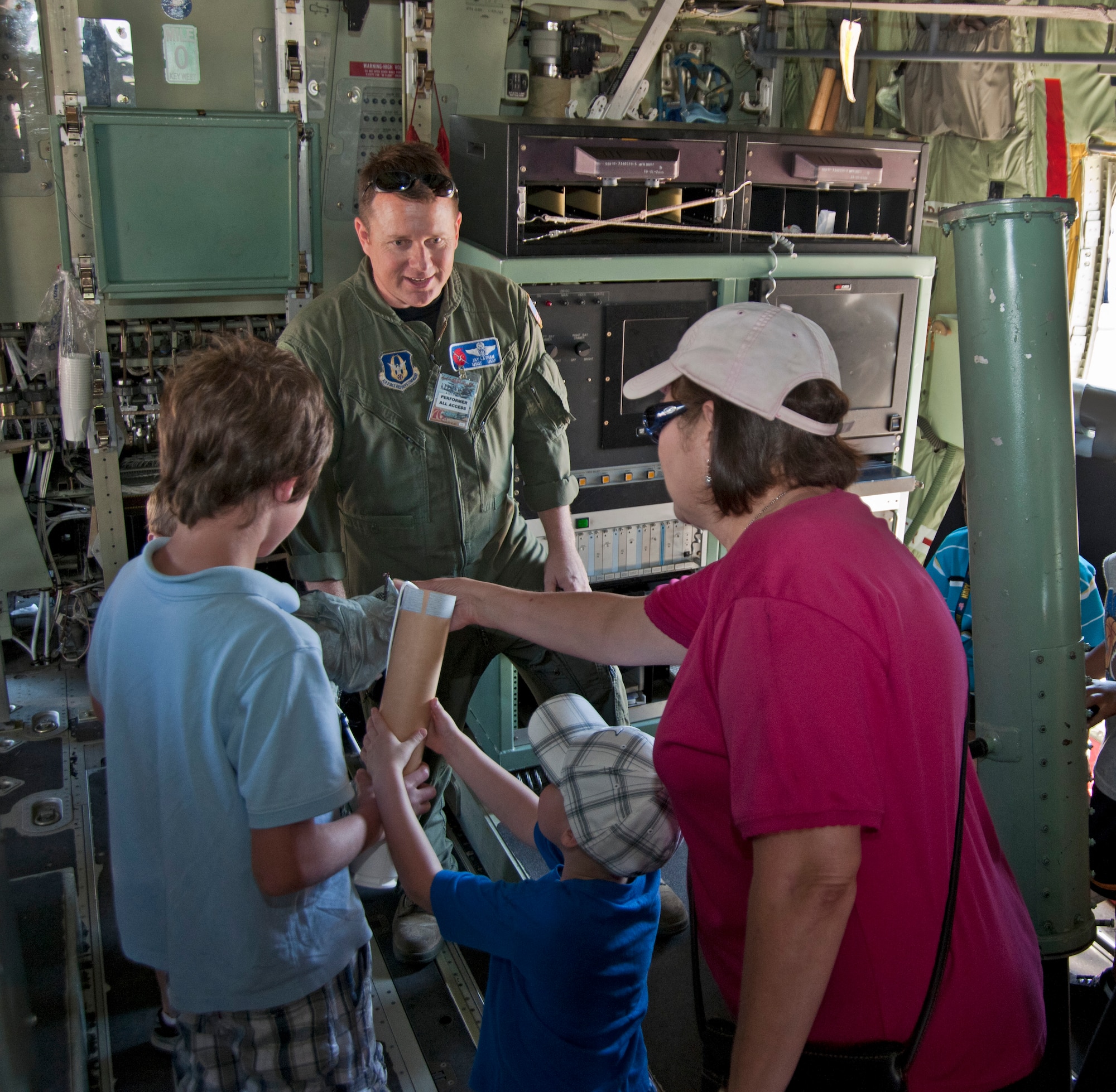 Master Sgt. Joseph Latham, 53rd Weather Reconnaissance Squadron loadmaster, demonstrates the use of a dropsonde to Zach Seal, nephew of Barb DeBlasi, 81st Training Wing digital media artist.  Ms. Deblasi and her nephew Zach learned about the Air Force Reserve's "Hurricane Hunter" mission while aboard a 403rd Wing static display of a WC-130J "Hurricane Hunter" at Keesler Air Force Base, Miss. during an airshow.  More than 160,000 people attended the biannual event here March 19-20.  The dropsonde is a vital piece of equipment used in the 53rd WRS Hurricane Hunter mission.