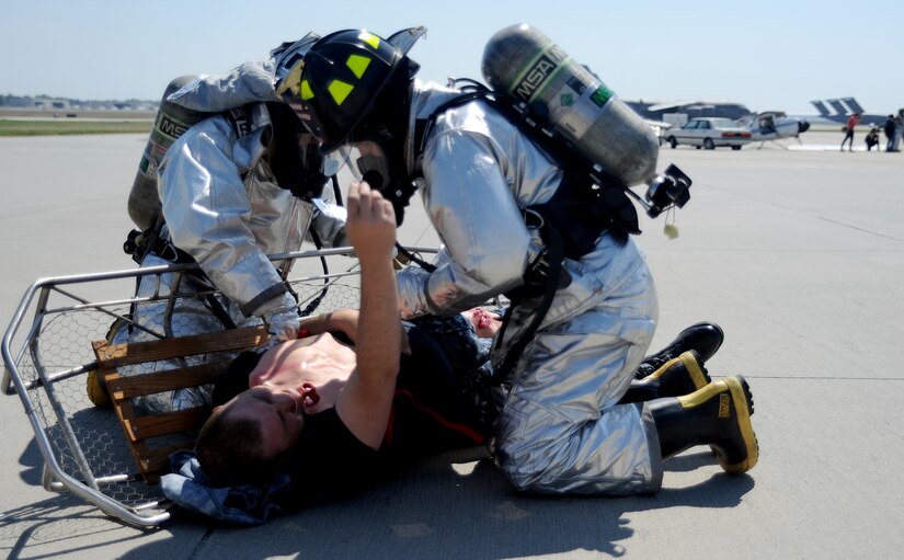Emergency responders from the 628th Civil Engineer Squadron roll a simulated victim onto a litter during a Major Accident Response Exercise March 22, 2011 on Joint Base Charleston, S.C. The MARE is a necessary step to prepare all Joint Base Charleston members for the upcoming 2011 Air Expo. The exercise is used to help test and train the supporting agencies who would respond in case of an emergency. (U.S. Air Force photo/Senior Airman Timothy Taylor)
