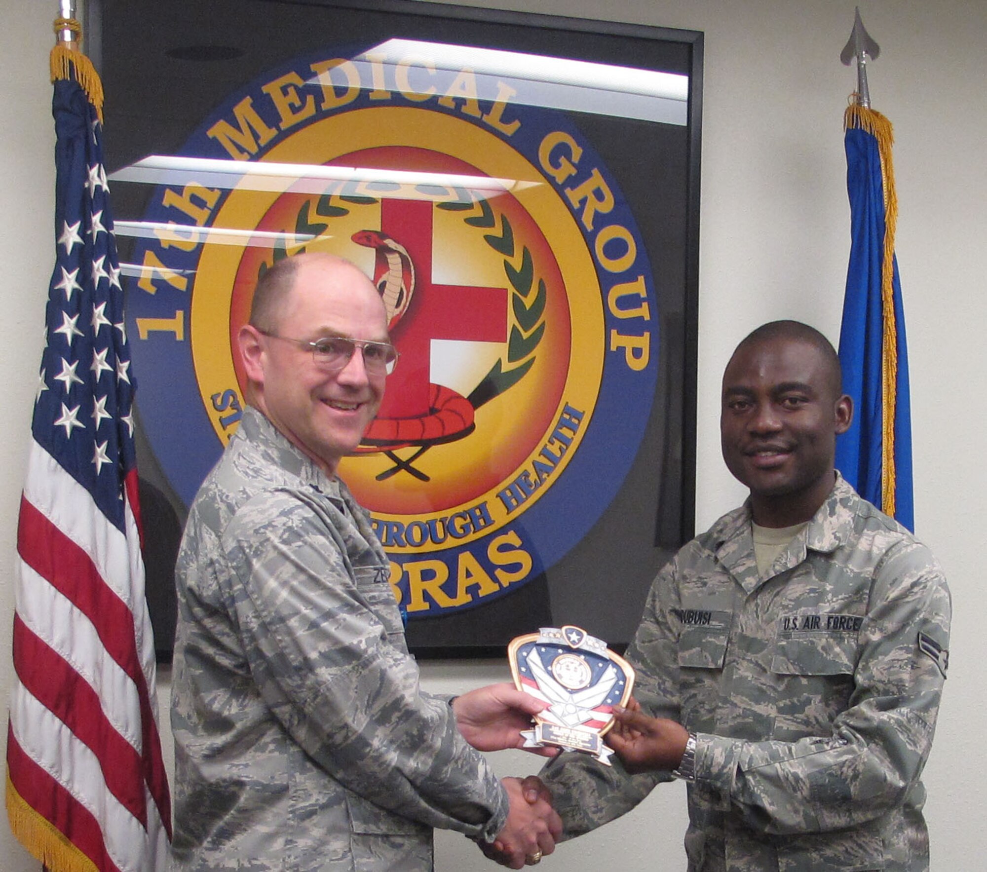 GOODFELLOW AIR FORSE BASE, Texas--Airman 1st Class John Ndubusi, Medical Support Squadron, receives the Airman of the Fourth Quarter award for the MDSS, July 2010 from Lt. Col. David Zemkosky, previous MDSS Commander. (courtesy photo)