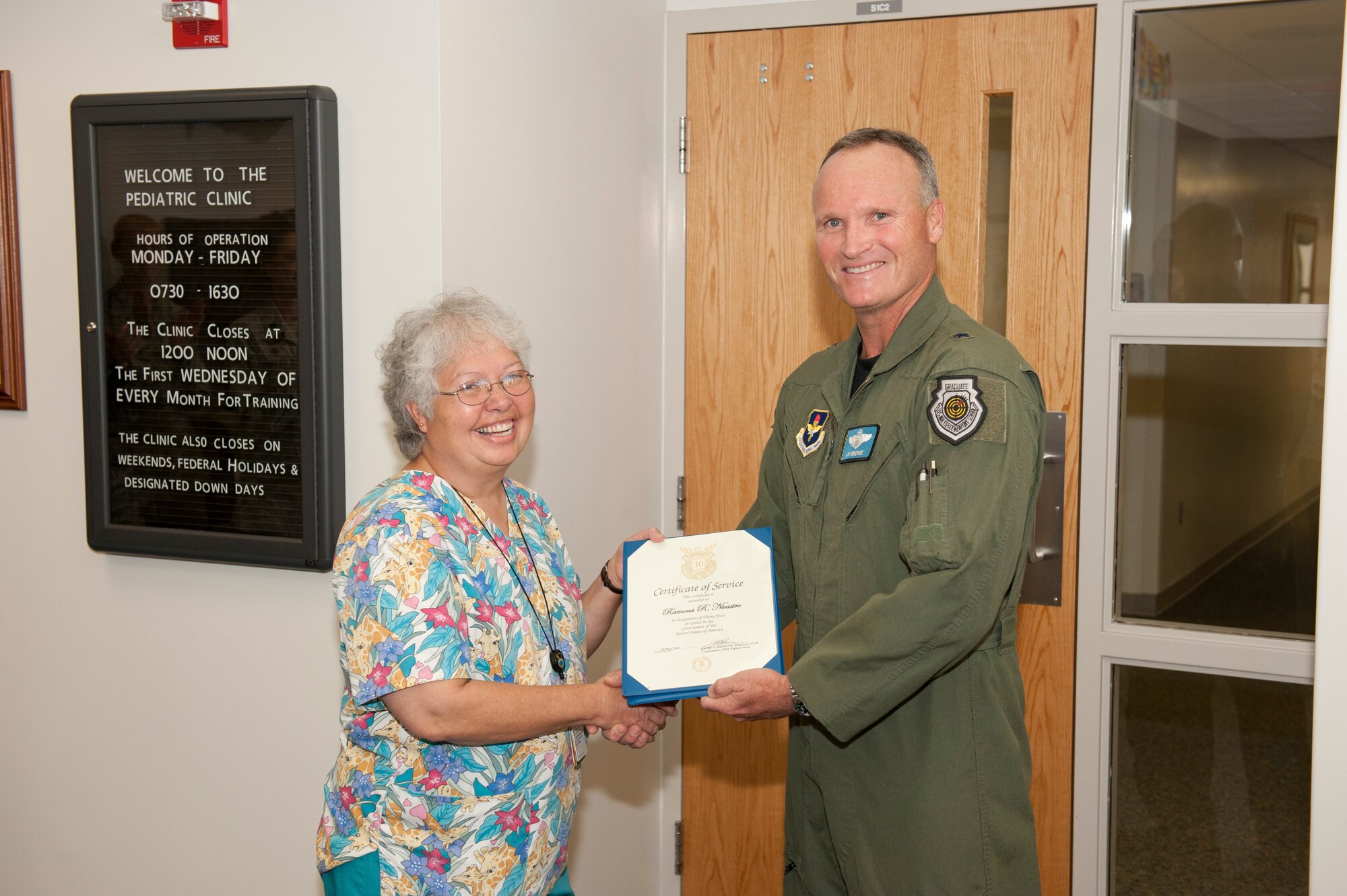 Brig. Gen. James S. Browne, 325th Fighter Wing commander, presents Ramona Nicastro, 325th Medical Group Pediactrics Clinic nurse, with a Certificate of Service in recognition of 30 years of service in the government of the United States March 22. Ms. Nicastro began civil service May 18, 1981 at George Air Force Base, Calif., as a nurse's aide. She and her family relocated to Tyndall in 1982, where she began working in the 325th MDG. She served in positions around the clinic, but for the last seven years, she has worked in pediactrics. Her primary duties include accessing, coordinating, facilitating and delivering nursing care to thousands of patients. "I have very much enjoyed my 30 years of nursing and the experiences that come with working with the military," she said. "I hope to have many more years here at Tyndall."  (U.S. Air Force photo by Jonathan Gibson) 