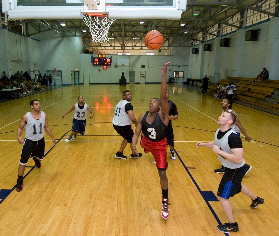 Prentis Martin, 89th Communications Squadron B team point guard, drives in for a lay-up against the 89 CS A-team players during an intramural basketball game playoff at the East Fitness Center March 22. The 89 CS B team won 35 to 32. (Photo by Bobby Jones) 