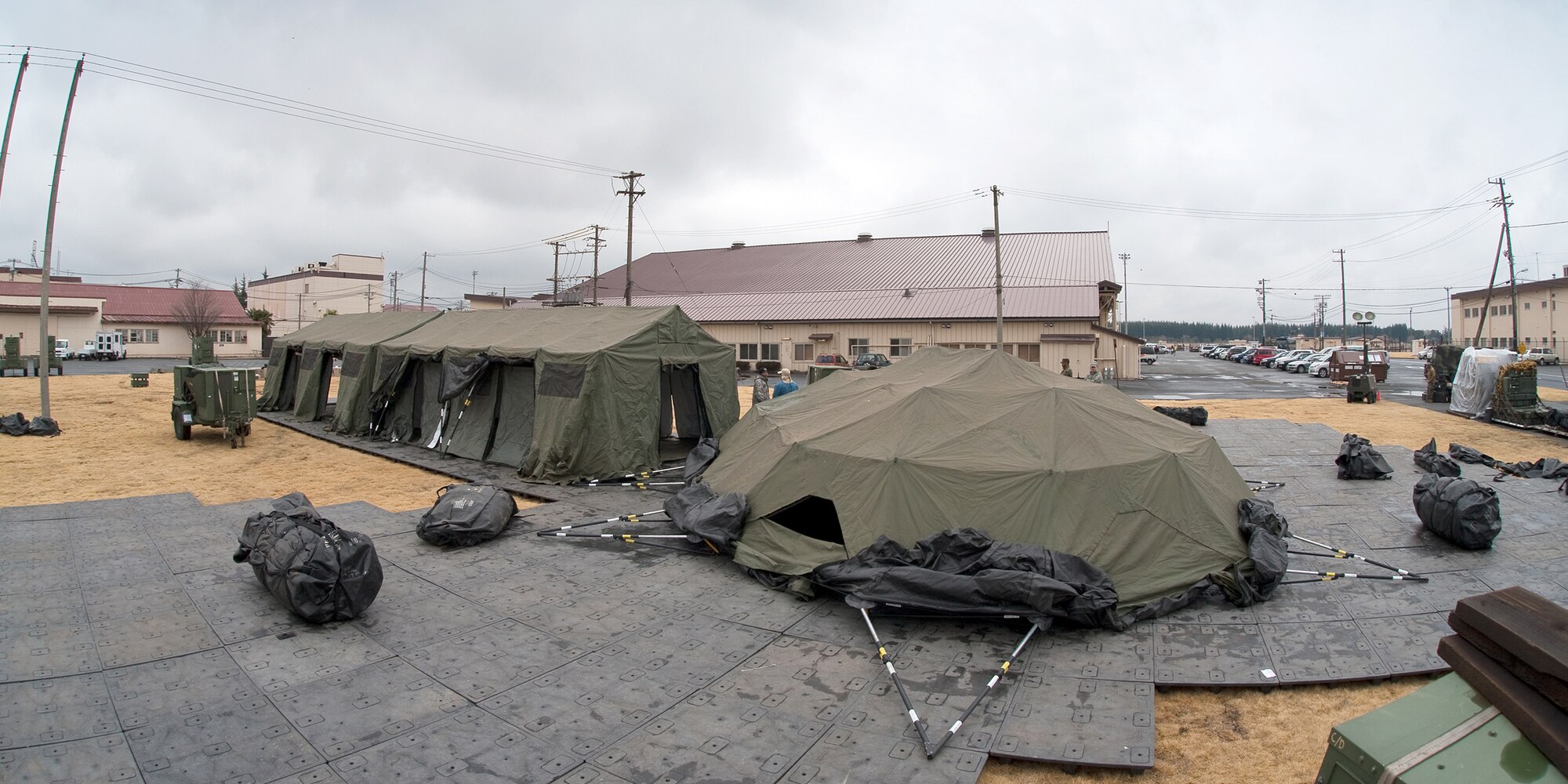Pacific Command personnel build tents March 22, 2011, at Yokota Air Base, Japan. The tents will provide additional workspace for personnel deploying to Yokota AB in support of Operation Tomodachi. (U.S. Air Force photo/Osakabe Yasuo) 