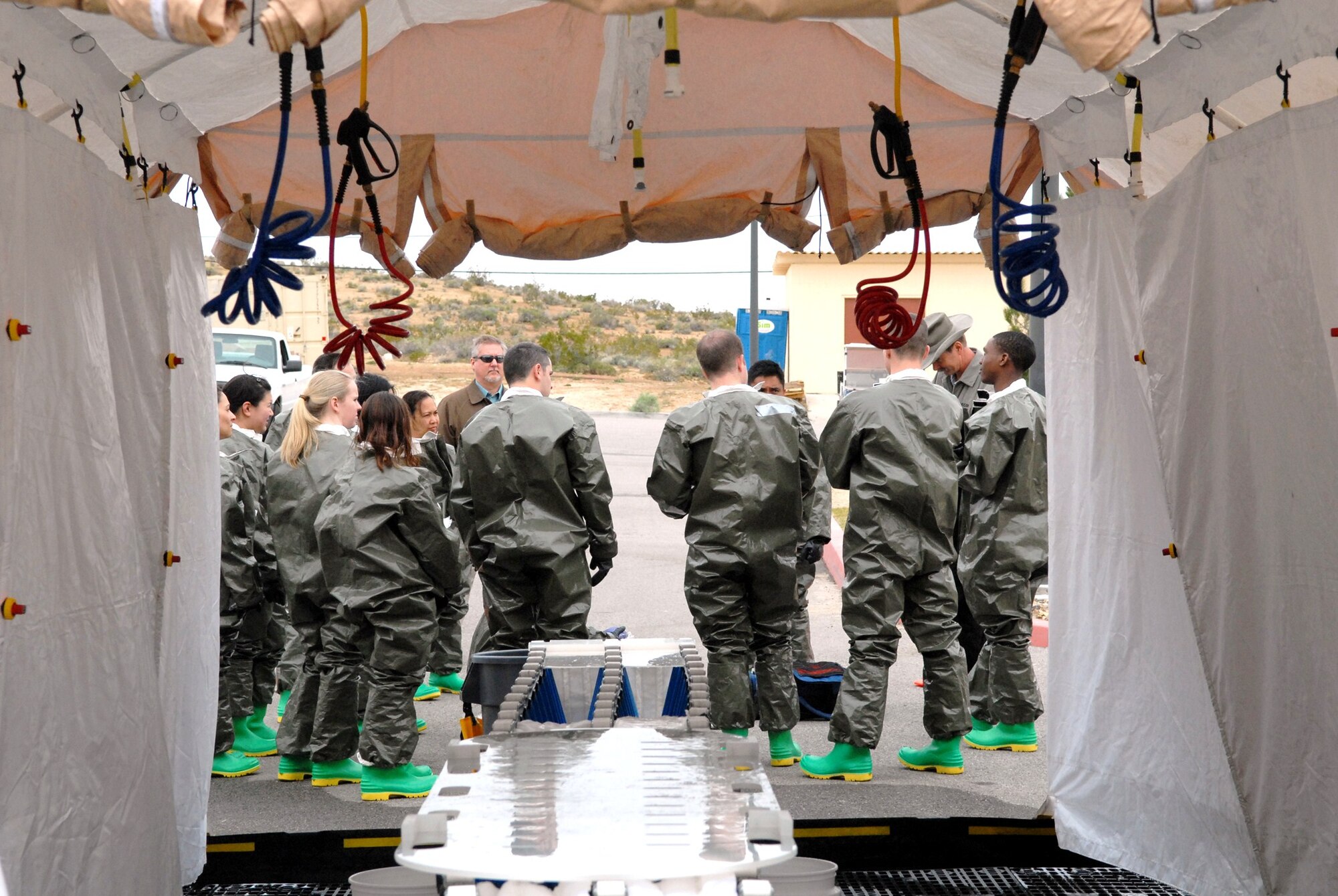 The In-Place Patient Decontamination Team from the 95th Medical Group, participate in decontamination training outside of the Medical Clinic March 17. As part of a three-day training course, the team practiced constructing a decontamination tent and performed proper procedures that would be required to treat contaminated patients. (Air Force photo by Kate Blais)